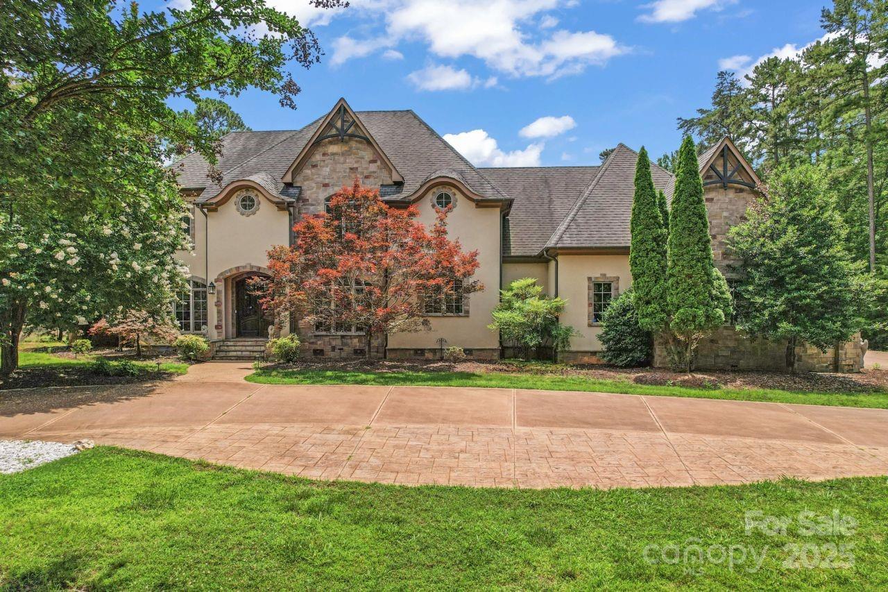 Nestled in the heart of the prestigious Tillery Tradition Country Club, this custom-built, European-inspired estate blends timeless sophistication with modern luxury. A dramatic two-story foyer and sweeping circular staircase showcase the home’s meticulous craftsmanship and elegant design. The chef’s kitchen, featuring all-new appliances (2023 & 2024), opens to a light-filled breakfast area overlooking the 14th hole and a hand-laid flagstone veranda—ideal for morning coffee or evening gatherings. Two gas fireplaces add warmth and charm, while the outdoor kitchen with built-in grill and granite countertops makes entertaining effortless. The luxurious primary suite provides a peaceful retreat, complete with a spa-like bath and heated floor. Additional highlights include a 3-car garage plus a golf cart bay, two Rinnai tankless water heaters, an encapsulated crawlspace, and full irrigation. With refined finishes and a thoughtful layout, this home delivers elevated golf course living.