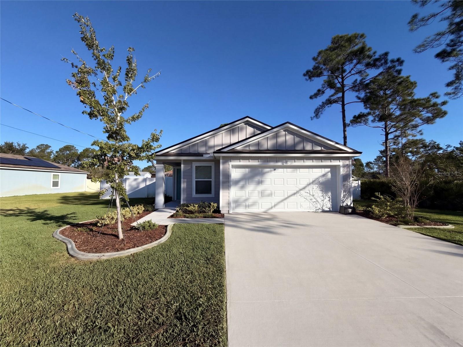 9 Radium Ln is a one-story Palm Coast home with a bright interior and an open, airy layout. White cabinetry, ample counter space, installed appliances, and a large center island shape the kitchen, creating a fully equipped space for cooking and entertaining. The adjoining living area has a high ceiling and a direct connection to the rear of the home. In the primary bathroom, a dual-sink vanity adds everyday convenience beside a separate walk-in shower, while another bathroom includes a tub and shower combination. A screened rear enclosure extends the living space outdoors beside the fully fenced backyard. A two-car garage completes this well-maintained residence with practical amenities and comfortable living spaces throughout every room. Included 100-Day Home Warranty with buyer activation