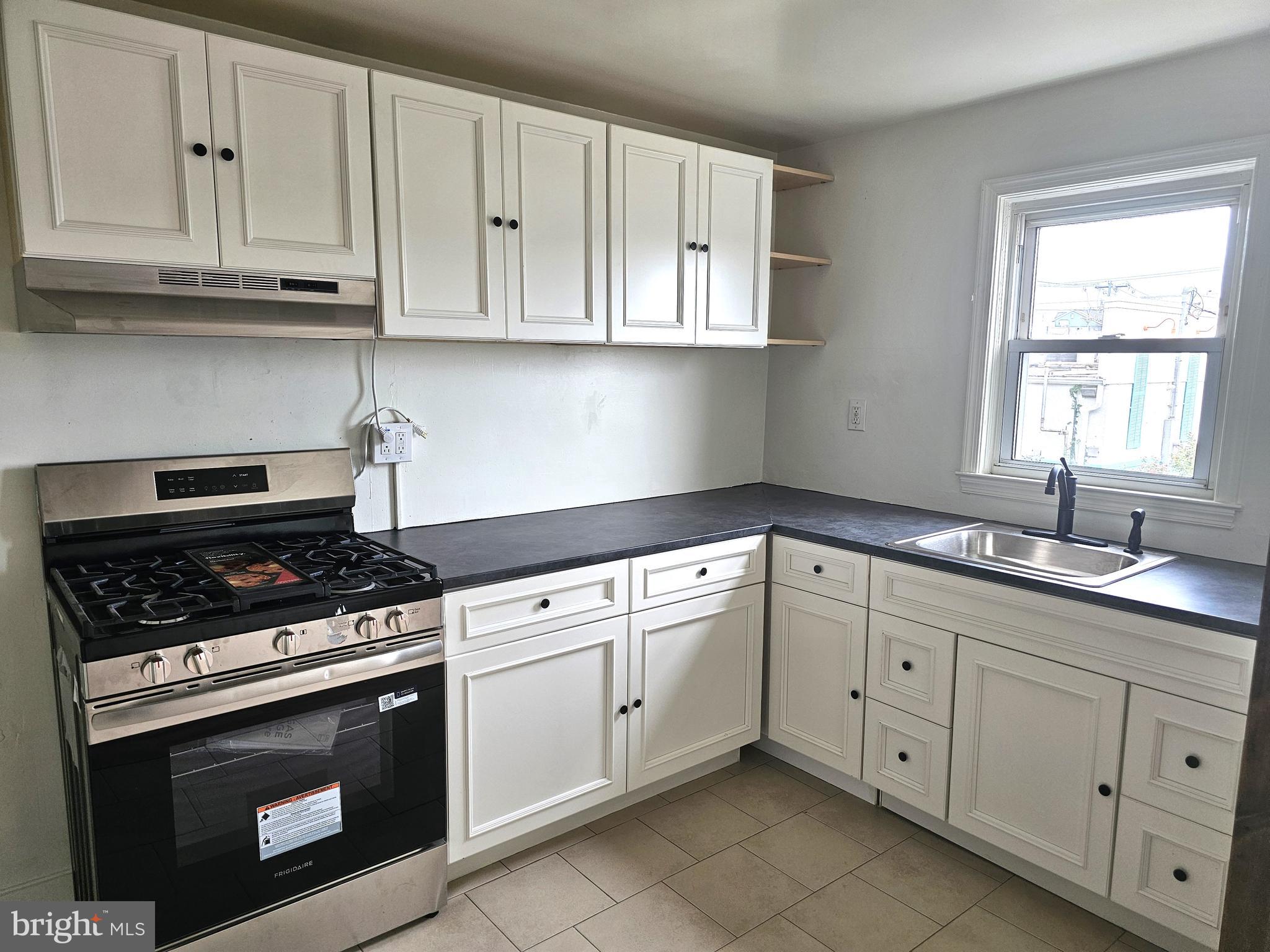 Completely renovated and move-in ready, this 4-bedroom, 2-full-bath townhome offers modern updates and a functional layout throughout. The beautifully renovated kitchen features a gas range and flows into the adjacent dining room, which opens to a spacious living room—perfect for everyday living and entertaining. Durable, low-maintenance laminate and tile flooring extend throughout the home.The upper level includes three comfortable bedrooms and a newly renovated full hall bath. The finished lower level provides a versatile fourth bedroom, a sitting area, a brand-new full bath, and a convenient laundry hookup. Additional updates include a new HVAC system and a new hot water heater for added peace of mind.A rare city amenity, the lower level also offers rear access to gated off-street parking. Conveniently located near major roadways and public transportation, this home combines modern comfort with everyday convenience. Schedule your tour today!