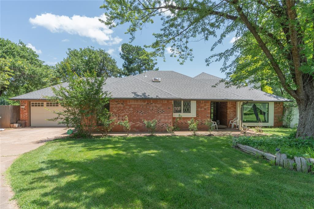 You've found a rare gem in East Edmond! This charming 3-bedroom, 2-bathroom home, ideally situated right off I-35 for an effortless commute, sits on an expansive and hard-to-find 1.17-acre lot. Enjoy the tranquility of mature trees and professional landscaping, creating your private oasis. Inside, the open-concept living room boasts vaulted ceilings and a sliding glass door leading to the backyard, while the kitchen offers abundant storage and granite countertops. Both bathrooms have been tastefully updated, featuring a tiled shower surround in the shared bath and a double vanity and beautifully tiled walk-in shower in the primary. An additional living space, perfect for cozy evenings, includes a gas-start brick fireplace and built-in bookshelves, all bathed in natural light from a large window. Step outside to a covered back deck, ideal for year-round enjoyment, overlooking the vast lot — perfect for gardening or envisioning your dream pool. The detached garage, with electricity and covered side storage, makes for an ideal workshop. This unique Edmond property won't last long! Call today to schedule your private showing.