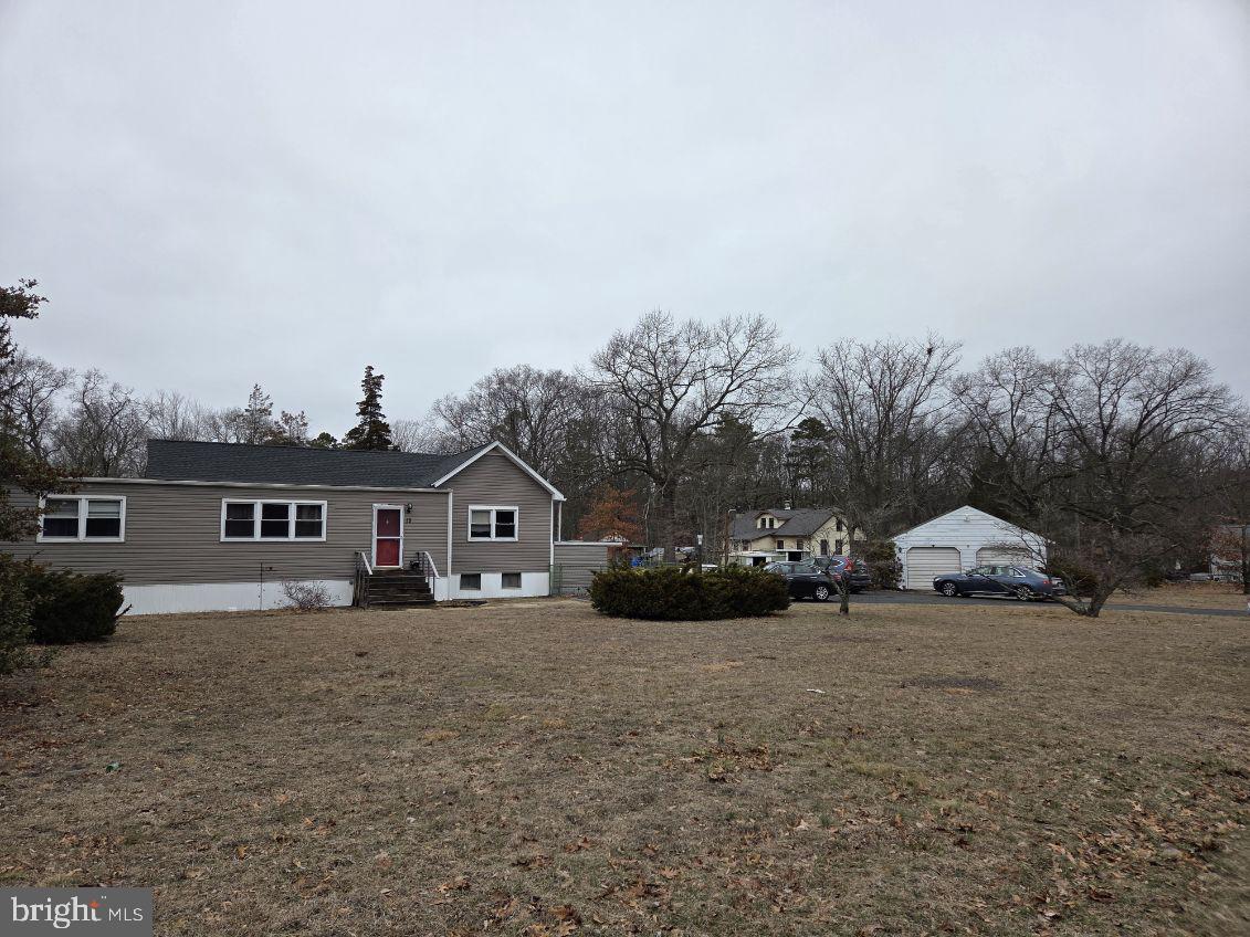 Discover this hidden gem! This spacious 3-4 bedroom ranch home awaits its new owners. Nestled on a generously sized lot, it features a large living room and dining area, along with an eat-in kitchen that accommodates a table. The property includes three well-proportioned bedrooms, an updated bathroom, and a newer powder room. Although there is no central air conditioning, window units are included. The home boasts updated vinyl windows and a newer dimensional roof (2018), as well as a newer garage roof (2020). While this residence requires some tender loving care and is being sold "as-is," the buyer will be responsible for obtaining the certificate of occupancy and any necessary repairs for any/all inspections.