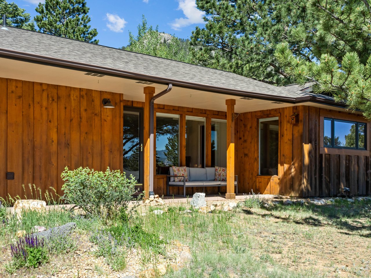 Tranquil Lane says it all. Single level upgraded light-filled home w/ living areas and an open floor plan, stunning hardwood floors and beautiful great room with cut stone fireplace, situated in a quiet neighborhood close to everything in Estes Park. The primary ensuite bedroom is on one side of the house offering peace and privacy. Kitchen has ample counter, prep and storage space. Serene outdoor spaces including covered patio. Quiet cul-de-sac location that is close to recreation center, hospital, downtown and golf course.