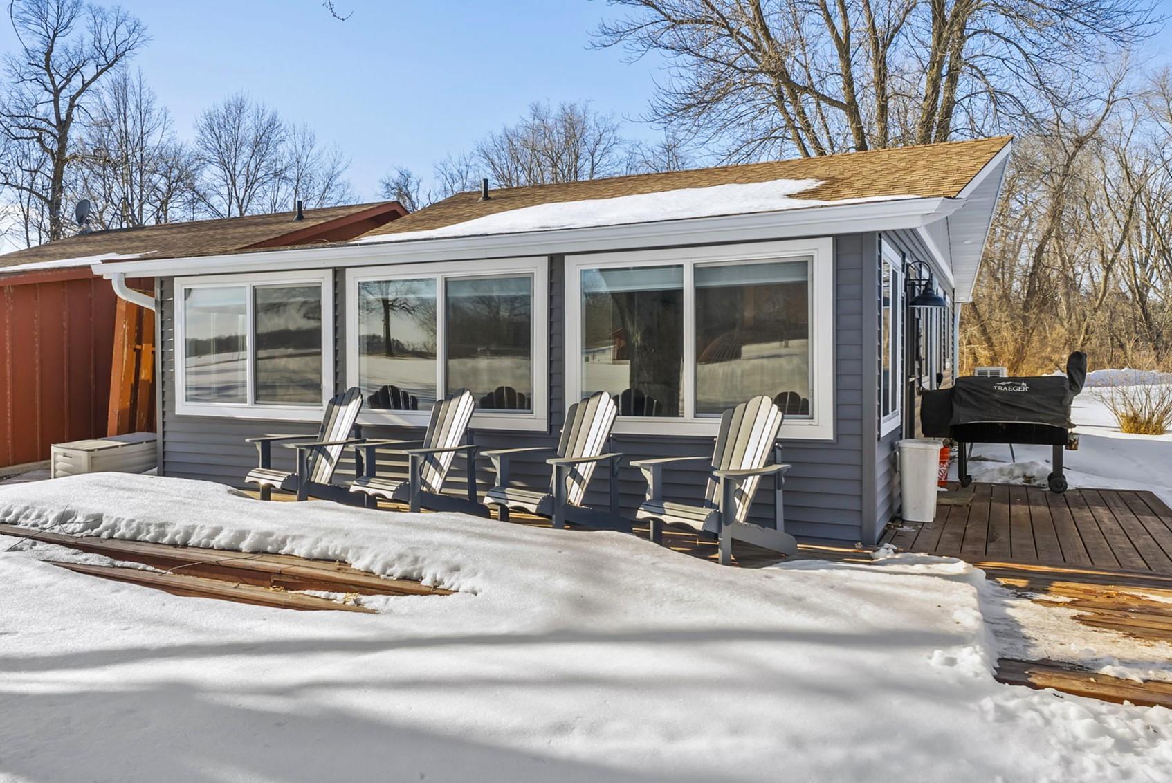 Stunning 2-bedroom, 1-bathroom retreat on Lake Ida—one of the area’s premier lakes with over 4,000 acres of crystal-clear water and exceptional fishing—offering effortless lake living in a peaceful Alexandria setting just minutes from shopping and dining. Part of a lake association that manages exterior upkeep, this beautifully updated cabin blends cozy charm with modern comfort, creating a low-maintenance getaway designed for easy relaxation and full enjoyment of the lake lifestyle.Inside, a bright, welcoming living area features durable luxury vinyl flooring (2019) and expansive windows showcasing serene natural views. Warm wood-paneled walls and ceilings add character, while the adjoining main living room includes shiplap accents, a ceiling fan, and an electric fireplace with custom wood surround (2023). The stylish kitchen offers stainless steel appliances, refinished white cabinetry (2024), tile backsplash, quartz countertops with matching sink (2025), an RO drinking water system, and a center island (2020) with breakfast bar seating.Two comfortable bedrooms provide ceiling fans, generous closets, and abundant natural light. The bathroom, accessed through a sliding barn door, includes a new vanity and toilet (2019) plus nearby storage. Outdoor living shines with a private deck (2018) overlooking green space and lake views, along with an RV outlet for added flexibility.Association amenities include lawn care, a community pool and deck, maintained common grounds, shared docks, and a dedicated boat slip with lift option. Additional updates include a water softener (2019), mini-split HVAC (2022), and updated doors, windows, and fixtures (2023).