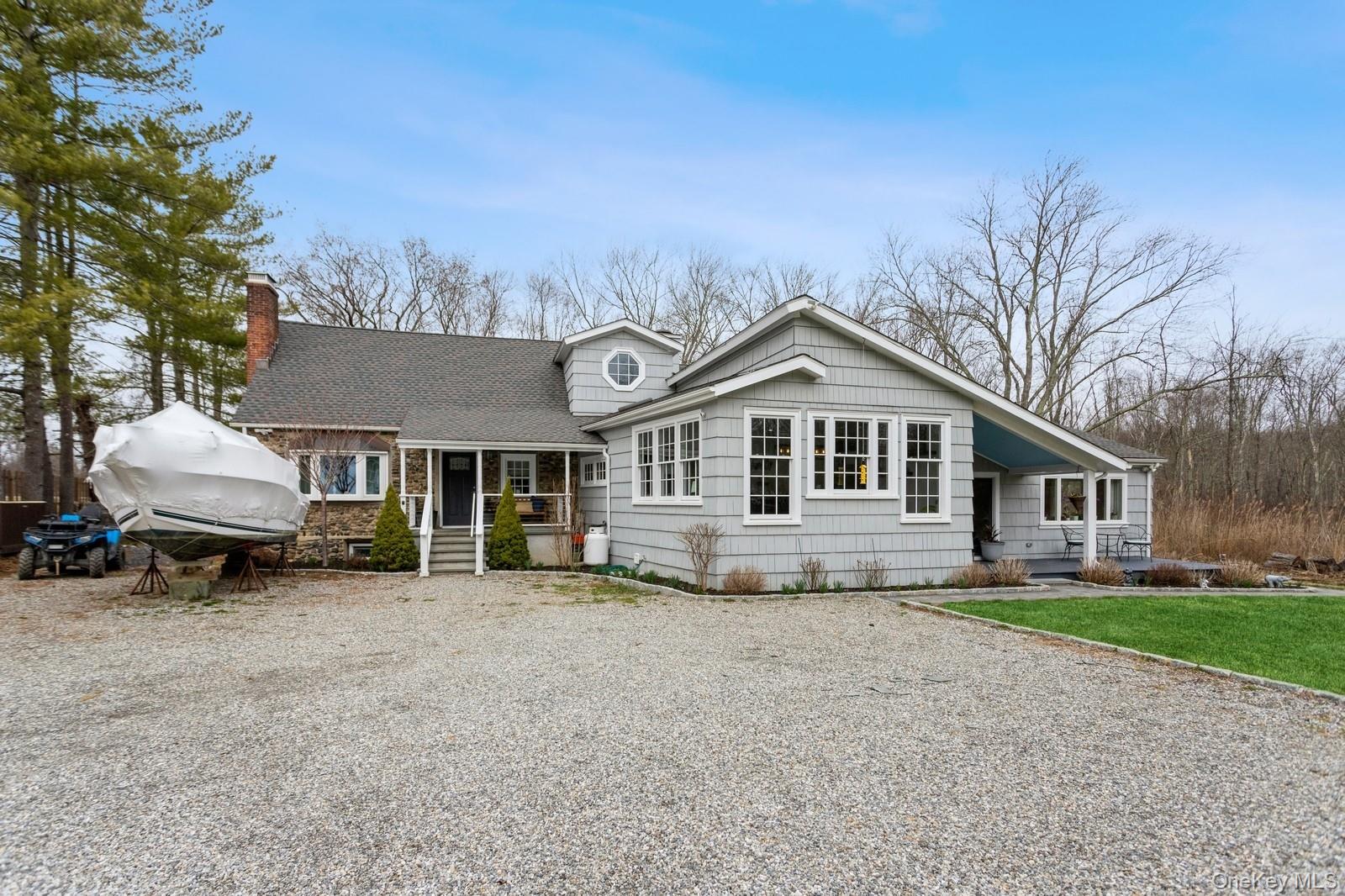 A Timeless Retreat with Modern Luxury in Lewisboro

Tucked away on 5.33 private acres, this extraordinary Cape Cod-Split Ranch is a seamless fusion of classic elegance and modern sophistication. Thoughtfully redesigned and fully upgraded in the past five years, this 5-bedroom, 4.5-bathroom estate spans 3,648 sq. ft., offering an unparalleled living experience. With five-zone heating and cooling in the main home and a fully independent in-law suite with its own utilities, this residence is designed for both comfort and versatility. The first floor welcomes you with a bright and spacious living and dining area, a sunken family room with sliding doors leading to an expansive deck, and a first-floor bedroom with custom built-ins. Two additional bedrooms, two full baths, a powder room, and a laundry room complete this level, offering seamless convenience and functionality. Upstairs, the attic bedroom includes a walk-in closet, while a Jack-and-Jill bedroom provides a well-appointed shared bath. Baseboard heating ensures year-round comfort, complementing the home’s thoughtful design. A private accessory suite offers independent living with its own kitchen, living room with balcony access, bedroom with walk-in closet, and full en-suite bath. Separate utilities provide complete autonomy, making it ideal for extended family or guests. The primary suite is a true retreat, featuring heated floors, a double vanity, a stand-up shower, and a skylight, evoking a spa-like ambiance. Every detail has been designed for both luxury and practicality. Beyond the interiors, the property offers a serene escape with a chicken coop (chickens included!) and a pool table that remains with the home. Located within the highly regarded Katonah-Lewisboro School District, this estate provides a perfect balance of privacy and accessibility, with convenient access to local amenities and major commuting routes. An exceptional opportunity to own a fully upgraded home that harmonizes timeless charm with modern indulgence.