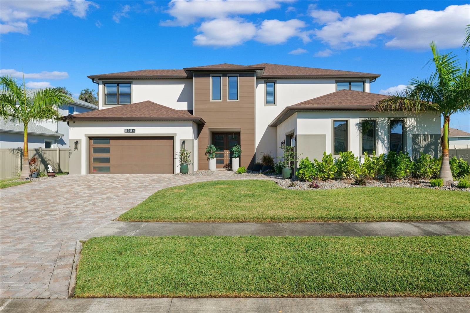 Under contract-accepting backup offers. Welcome to 8684 Sanders Tree Loop, a breathtaking 4,977 sq. ft. luxury residence nestled in the highly sought-after Epperson Lagoon Community—home to Florida’s first and most iconic man-made crystal lagoon. Built in 2021, this modern, resort-style estate blends elegance, comfort, and upscale living in every detail.From the moment you arrive, the home makes an unforgettable impression. Step inside to soaring ceilings, expansive living spaces, and designer finishes that showcase a perfect balance of sophistication and warmth. Natural light floods the open-concept layout, highlighting premium flooring, custom architectural details, and an effortless indoor–outdoor flow.At the heart of the home sits a chef-inspired gourmet kitchen, boasting high-end appliances, an oversized island, premium cabinetry, and generous storage—ideal for both everyday cooking and hosting unforgettable gatherings. Multiple living areas, a luxurious formal dining space, and thoughtfully designed bedrooms offer versatility for any lifestyle.The crown jewel of the property awaits outdoors: a stunning saltwater pool, custom-designed to create your own private oasis. Whether entertaining, relaxing after a day at the lagoon, or enjoying Florida’s endless sunshine, this backyard sanctuary transforms your home into a permanent vacation retreat.Upstairs, the grand owner’s suite offers a serene escape with spa-like features, abundant space, and designer touches throughout. Additional bedrooms and flexible loft/bonus spaces provide room for work, play, or multi-generational living.Located just minutes from the world-famous Epperson Lagoon, residents enjoy unmatched amenities—white sandy beaches, water activities, live entertainment, golf cart-friendly paths, and a vibrant community lifestyle.If you’re searching for luxury, space, and an unbeatable resort lifestyle, this extraordinary home at 8684 Sanders Tree Loop is the one.
