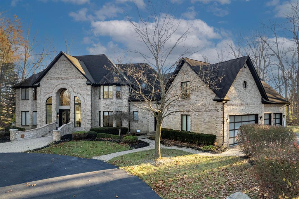 Welcome home to this exquisite, completely remodeled all-brick luxury residence, set amidst 10 acres of breathtaking scenery and a tranquil pond. With four bedrooms and six-and-a-half bathrooms, this stunning property showcases a dramatic two-story foyer with marble floors and sleek steel entry doors, accompanied by custom stairs with unique iron handrails. The gourmet kitchen is appointed with high-end Wolf appliances, Sub Zero refrigerator, custom cabinetry, and a picturesque garden window. Two elegant limestone fireplaces add sophistication. The expansive master bedroom boasts a pan ceiling, while the partially finished walkout lower level features a generous bar, exercise room, full bathroom with sauna, and unfinished movie theater.