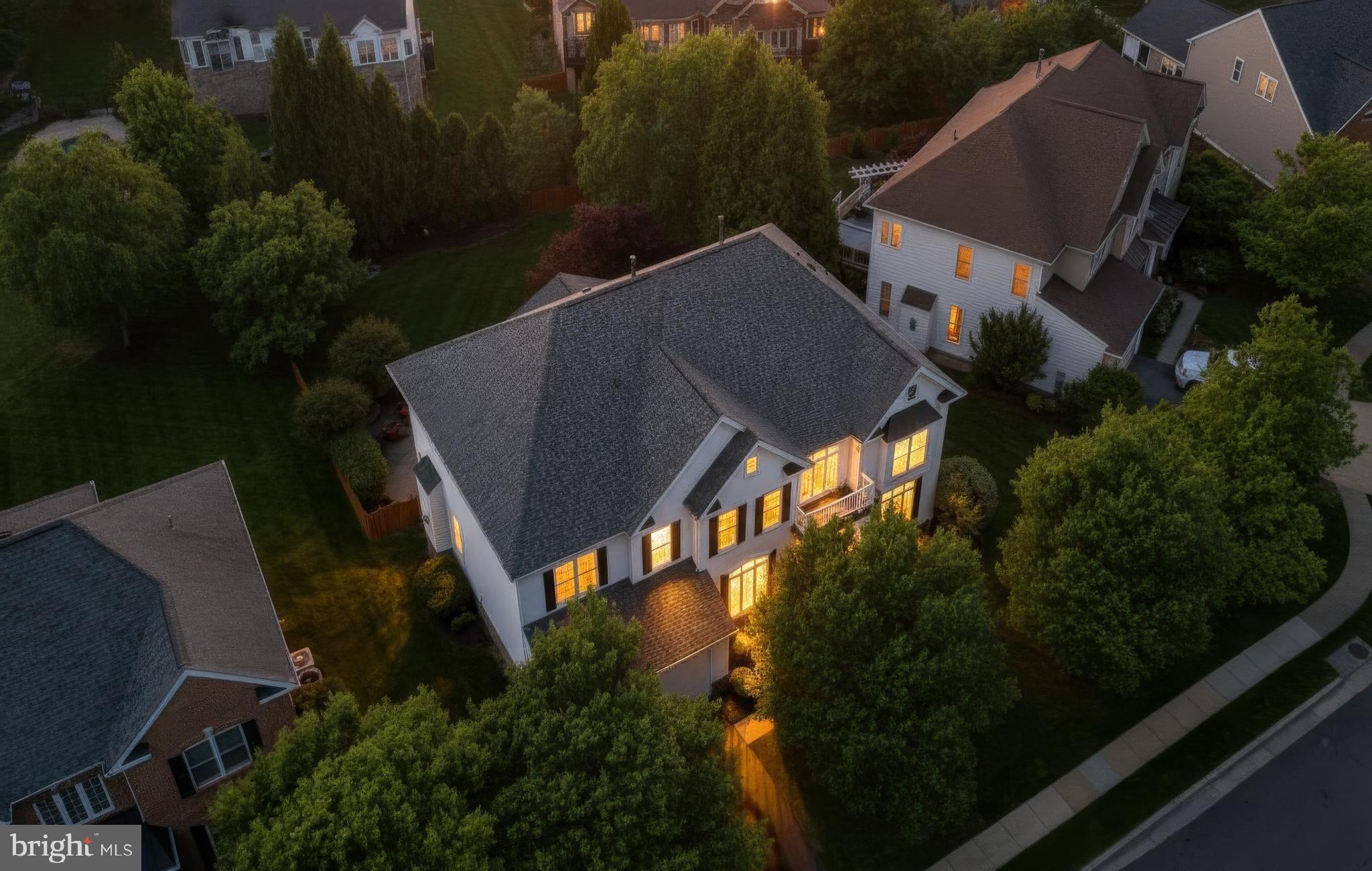 A gorgeous home is ALWAYS worth the wait. Boasting nearly 6,000 square feet, this residence lives large and effortlessly, defined by signature spaces including an impressive foyer, a soaring two story great room, a sun splashed sunroom, an updated chef’s kitchen, and 4 generously sized bedrooms. The finished lower level is another standout, and the private backyard — complete with a patio, stone fireplace, mature trees, irrigation, and a flat fenced yard — delivers the perfect finishing touch.Before you even step inside, the stately façade, mature trees, and expansive fenced  in backyard with an array of  refreshed features- a composite  deck, custom wrap around paver patio and a stunning outdoor fireplace.  Plus, a multi zone irrigation system keeps the grounds lush and polished, while landscape lighting adds a touch of twilight magic.Step inside and the home unfolds with a sense of ease and refinement. The two story foyer-accented by an updated chandelier and a gracefully turned staircase- sets a welcoming tone before opening to the Formal Living Room, where this beautifully proportioned space offers views of the front gardens. Further along, the elegant Dining Room offers serene tree views and a well appointed Butler’s Pantry- with sink- connects to the heart of the home, your Chefs Kitchen Here, beautiful neutral cabinetry shows off the sleek granite countertops and custom backsplash. The vented chef’s hood stands tall against the modern stylish pendants and under and over cabinet lights- taking this kitchen to the next level!  Just beyond the kitchen, the sunroom becomes an irresistible gathering place— a light filled retreat wrapped in panoramic views of the lush, private backyard with Mature flowering trees and a Stately row of Evergreens for year round color and privacy.From here, the Great Room reveals itself with Dramatic Presence. Towering stacked windows allow endless natural light, while the Floor to Ceiling Stone Fireplace anchors the room with warmth and character. A modern chandelier adds a refined architectural touch and New plush carpeting enhances the room’s inviting comfort. The Upper Level continues the home’s thoughtful design with a series of modern updates that enhance both comfort and style. Enjoy New plush carpeting in all bedrooms and each Bathroom has been refreshed with quartz or granite countertops, updated faucets and lighting, and stylish mirrors that bring a clean, contemporary feel. The Owner’s Suite is beautifully proportioned, offering a serene retreat with a spacious Sitting Room and Two walk in closets featuring Custom Organization. The Luxury Bath feels indulgent, complete with a soaking tub, walk in shower, and private water closet. The secondary bedroom configuration is exceptional. A Prince/Princess suite enjoys its own refreshed ensuite bath, walk in closet, and charming window bench. Bedrooms three and four are generously sized with ample closet space and share a sparkling Jack and Jill bath, thoughtfully updated to match the home’s elevated aesthetic.The finished lower level is a true extension of the home’s Livable Luxury. A Restaurant Inspired Bar anchors the space, offering the perfect setting for Entertaining. The expansive Recreation Room accommodates multiple zones — media, gaming, cards, pool — while a separate den provides flexibility for work, guests, or hobbies. A full bathroom, dedicated home gym, and abundant storage round out this level.  A double wide walk up staircase provides easy access to the backyard and patio, making indoor outdoor living seamless.
