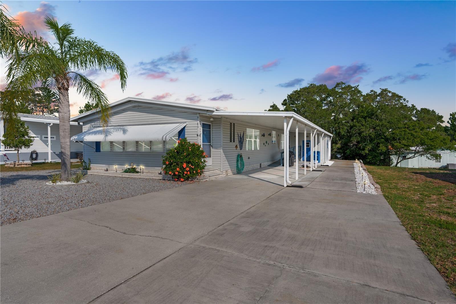 A pristine, move-in ready home in a gated 55+ community with tons of amenities? No, you're not dreaming, it's your dream home come to life! This Palm Harbor-built mobile home in highly desirable Brookridge is beautiful inside and out, starting with the low-maintenance xeriscaped lawn. Inside, the split-bedroom floor plan comes furnished and is fully turnkey! It's both expansive and functional, with vaulted ceilings adding volume to the space. A wood-burning fireplace flanked by two cushioned window seats creates a cozy focal point in the living room. The kitchen is bright and open with lots of cabinet and counter space, a breakfast bar, pantry, and a large eating nook. Skylights gently illuminate the luxury vinyl plank flooring here, which extends into a big family room. It's a great spot where everyone can gather for game or movie night. Retreat to the primary suite after a long day of golfing and socializing at the clubhouse; it's private with a large closet. The ensuite primary bathroom offers dual sink vanities and a walk-in shower. The other two guest bedrooms are also quite sizable; one of them has extensive built-in shelving, expanding your storage capacity. They share a guest bathroom with a tub/shower combo. An indoor utility room provides easy access to the washer and dryer. A newer wooden ramp leads out to the covered carport, where the workshop and storage area await. Here, you'll find a workbench and a roll-up garage door that allows you to effortlessly park your golf cart inside. Brookridge is a premiere 55+ gated community filled to the brim with amenities, including 24/7 security, a golf course, clubhouse, community pool, and a variety of sports courts, like tennis, shuffleboard, and bocce ball. Additionally, there's numerous clubs and activities to join for those who enjoy an active, social lifestyle. It's close to a plethora of shopping and dining options in the nearby plazas, plus medical facilities, parks, and more. Weeki Wachee Springs State Park is only 20 minutes away, where you can paddle the river, meet real mermaids, and enjoy the waterpark in the summer months. The Suncoast Parkway is literally moments away, so Tampa and attractions like Busch Gardens, Raymond James Stadium, and the Hard Rock Casino are only about an hour to the south. And the magic of Orlando's theme parks lies less than 2 hours to the east. Private tours are available! Whether you're seeking a seasonal escape from cooler climes or a full-time fun spot to call home, you shouldn't miss the chance to live the Florida lifestyle you deserve. See this home today!