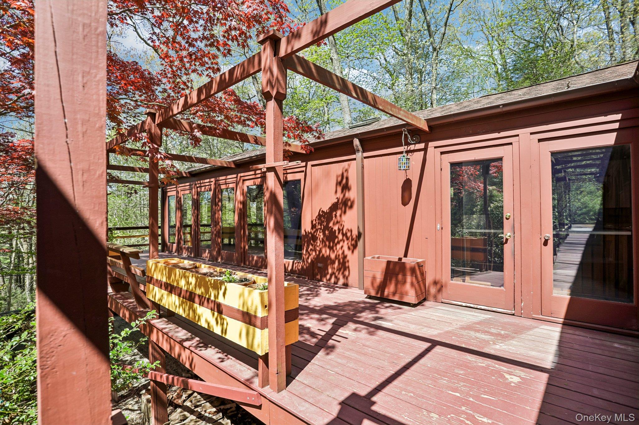 Welcome to 59 Shad Road West in Pound Ridge—a rare opportunity for New York City buyers seeking a seamless transition from urban living to a private, nature-rich retreat without sacrificing accessibility. Set on 2.3 tranquil acres, this 3-bedroom, 2-bath home offers the kind of space, quiet, and natural beauty that’s simply unattainable in the city. With deeded rights to the Lake just steps away, the property invites a lifestyle centered around relaxation, fresh air, and year-round outdoor enjoyment. The home’s layout is both functional and inviting, featuring a cozy kitchen, a spacious dining room perfect for hosting weekend dinners, and a large living room anchored by a wood-burning stone fireplace—ideal for unwinding after a busy week. Whether you're working remotely or escaping for the weekend, the atmosphere is equally comfortable and restorative. Outdoor living is where this property truly shines. A wraparound deck and screened-in porch create effortless indoor-outdoor flow—perfect for morning coffee, evening cocktails, or casual entertaining. The rooftop deck offers a unique vantage point to take in the peaceful surroundings, while a private path leads directly to the lake, making it easy to enjoy kayaking, nature walks, or simply disconnecting from city life. Despite its serene setting, the home is within easy reach of major roadways, offering a manageable commute to New York City when needed. Nearby local restaurants as well as Scotts Corners provides charming local shops, and everyday essentials, giving you the best of both worlds—rural tranquility with convenient amenities. An unfinished lower-level basement adds valuable storage and potential for customization, whether you envision a home gym, studio, or additional living space. For those looking to trade noise for nature, and congestion for calm, 59 Shad Road West delivers a compelling lifestyle upgrade—without leaving the orbit of the city.
