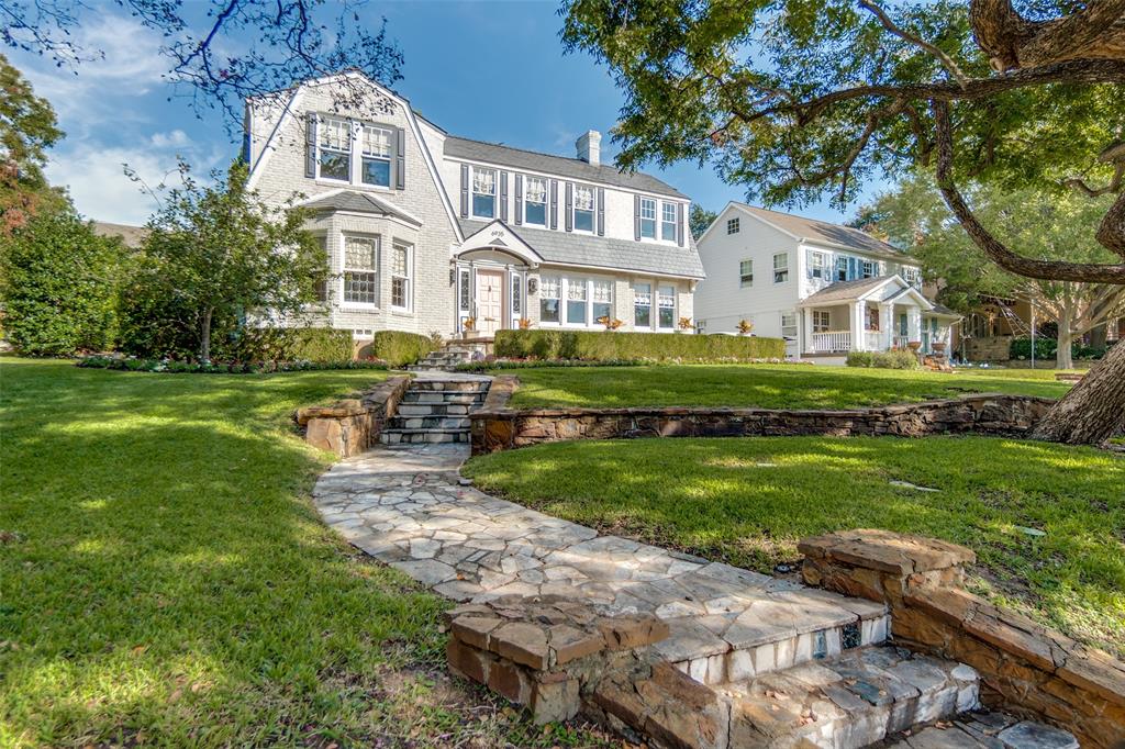 Perched atop a hill on Lakeshore Dr., is a rare opportunity in the heart of Lakewood - the original home of Lee Kraft (of Dines & Kraft). Designed by architect Bertram C. Hill, this 1927 Dutch Revival blends original heritage with an extensive list of updates from a 2014 remodel. Original arches, stained glass windows, decorative molding, plaster walls & coved ceilings remain, among many other details - capturing the classical charm. The first floor offers a seamless floorplan. The beautifully appointed kitchen & breakfast room flow into the family room. Additionally, the morning room boasting the signature Dines & Kraft morning tile, formal living room & dining room are all prime for entertaining. Upstairs lies the expanded primary suite with spacious walk-in closet & well-appointed bath, along with 3 other bedrooms and a laundry room. Quarters with a kitchenette, full bath and murphy bed offer extra room for guest overflow. A spacious backyard is the perfect place for children to play or entertain outdoors. This is a unique opportunity to own a piece of Lakewood history – just in time for 6935 Lakeshore to ring in its 100th birthday.
