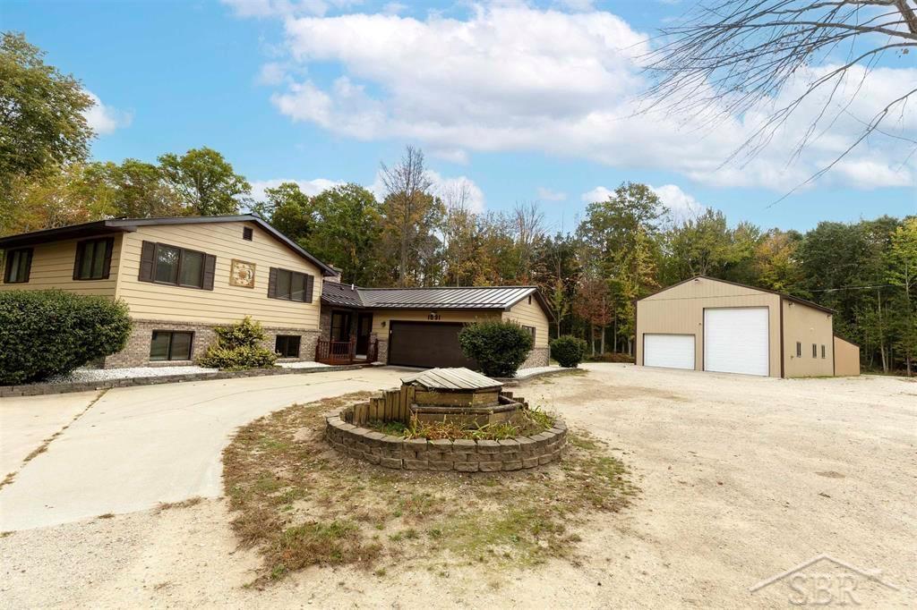 CAPTIVATING ON CASTOR! Looking for a beautiful home, incredible property and really nice pole barn? Built in 1981, this 4 bedroom, 2 bath home sits on a wooded 6 acres in Lee Twp far enough out of town to be very private but close enough to still have all the conveniences of Midland just minutes away. new flooring has been installed throughout the house and freshly painted. A wood fired boiler handles the heating for the house and pole barn (in floor heat), but the house also has an LP boiler as well. The pole barn is 30x40 (16' walls) with a 30x30 lean-to addition on the back. It also has a furnace and central air! Spray foam was added along with a loft and office space.  The yard is a child's dream with massive playground/playhouse and above ground pool. You truly have to see this backyard set up to believe it. Trails run through the 6 acres and there is plenty of additional acres of state land to hunt and roam on. Call Today!