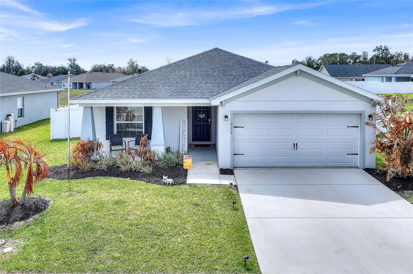 Beautifully maintained one-story home located in the desirable community of The Lakes II in Lake Alfred, offering 1,715 square feet of thoughtfully designed living space with 4 bedrooms, 2 bathrooms, and an open-concept layout perfect for both everyday living and entertaining.The bright and functional floor plan creates a seamless connection between the kitchen, dining café, and gathering room, delivering a comfortable flow throughout the home. The open kitchen features 36" white shaker-style cabinetry, Samsung stainless steel appliances, a walk-in pantry, and a spacious island, all fully open to the main living area for effortless entertaining.Luxury wood-look vinyl plank flooring enhances the living areas, laundry room, and bathrooms, while stain-resistant carpeting provides comfort in the bedrooms. The owner’s suite offers a private retreat complete with a generous walk-in wardrobe and an en-suite bath featuring dual vanities, a tiled shower, and a private water closet.Step outside to enjoy the extended lanai and fully fenced backyard, providing privacy and the perfect space for outdoor gatherings, pets, or relaxing evenings at home. Additional highlights include a 2-car garage, custom-fit window blinds, architectural shingles, and energy-efficient insulation and windows for year-round comfort and efficiency.Situated in a quiet residential neighborhood, this home offers convenient access to major highways for easy commuting to Orlando, Tampa, and throughout Central Florida. Enjoy close proximity to shopping, dining, parks, lakes, and local attractions while living in one of Lake Alfred’s most welcoming communities.
