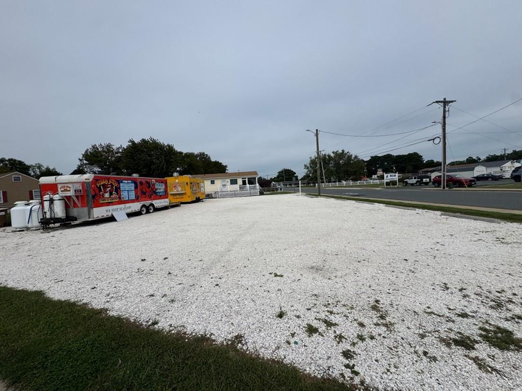 Unique Investment Opportunity! Highly Visible CORNER LOT in a prime location, this property is ready to generate immediate income. Some Key features:  C-3 Zoning ideal for a wide range of business uses. *Electric power on site with two (50-amp) circuits. Water Meter installed. Shell Parking Lot with convenient access. *Hydrant at the property. * Shared septic system with capacity for a two-bedroom set up. Currently the lot is generating $1600/month ($19,200/year) in food truck rental income, with potential to expand.  a strong return for investors wanting cash flow and long term value. The lot is versatile  for income, businesses, or a residential home build!  Income & potential!