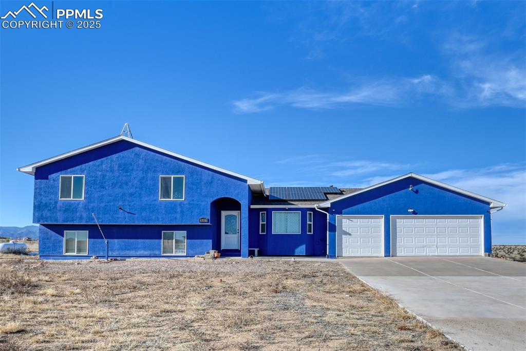 Discover this Gem! Just off Highway I- 25 between Colorado Springs and Pueblo, this 4-level house cannot be missed. It sits on 8.2 acres of land, fenced and zoned RR-5 for horses and other animals. Surrounded by open space, the property offers breathtaking views of the Mountain Range and Pikes Peak. Upon entering the residence, you will notice the remotely operated gate and a concrete driveway leading to the 5-car attached garage; two tandems and one spot for a compact car. The house features 4 bedrooms, 3 full bathrooms and an unfinished basement with a total of 3,117 square feet. Open concept layout on the main level has a kitchen with a breakfast bar, stainless steel appliances and granite countertops which then flows into the dining area and living room. From the dining room step outside to the covered patio and a wood deck and enjoy the views while relaxing in this idyllic setting. The laundry room is spacious and located on the main level with included washer & dryer. There are 2 bedrooms upstairs and 2 bedrooms located on the lower level. The Primary bedroom is generously sized with two walk-in closets, a 5-piece master bathroom with double vanity, a separate shower and a bathtub. The other bedroom upstairs is extended with a connected space, which can be treated as a 5th bedroom but unconforming. Lower level of the house is made for entertainment; it features a family room with an electric fireplace, two ample bedrooms, a full bathroom and below that unfinished basement with a gym mat for exercise enthusiasts. No HOA fee on this property! Incredible improvements done by the owners include Radon Mitigation System, Water Softener, Newer AC/furnace combo, Freshly painted interior; EV charger in the garage;Paid OFF Solar Panels to save on your energy bill. The house is Move-in Ready! Indulge yourself by owning a slice of what Colorado has to offer not too far away from the city with modern living interiors and convenient upgrades. Definitely worth a closer look!