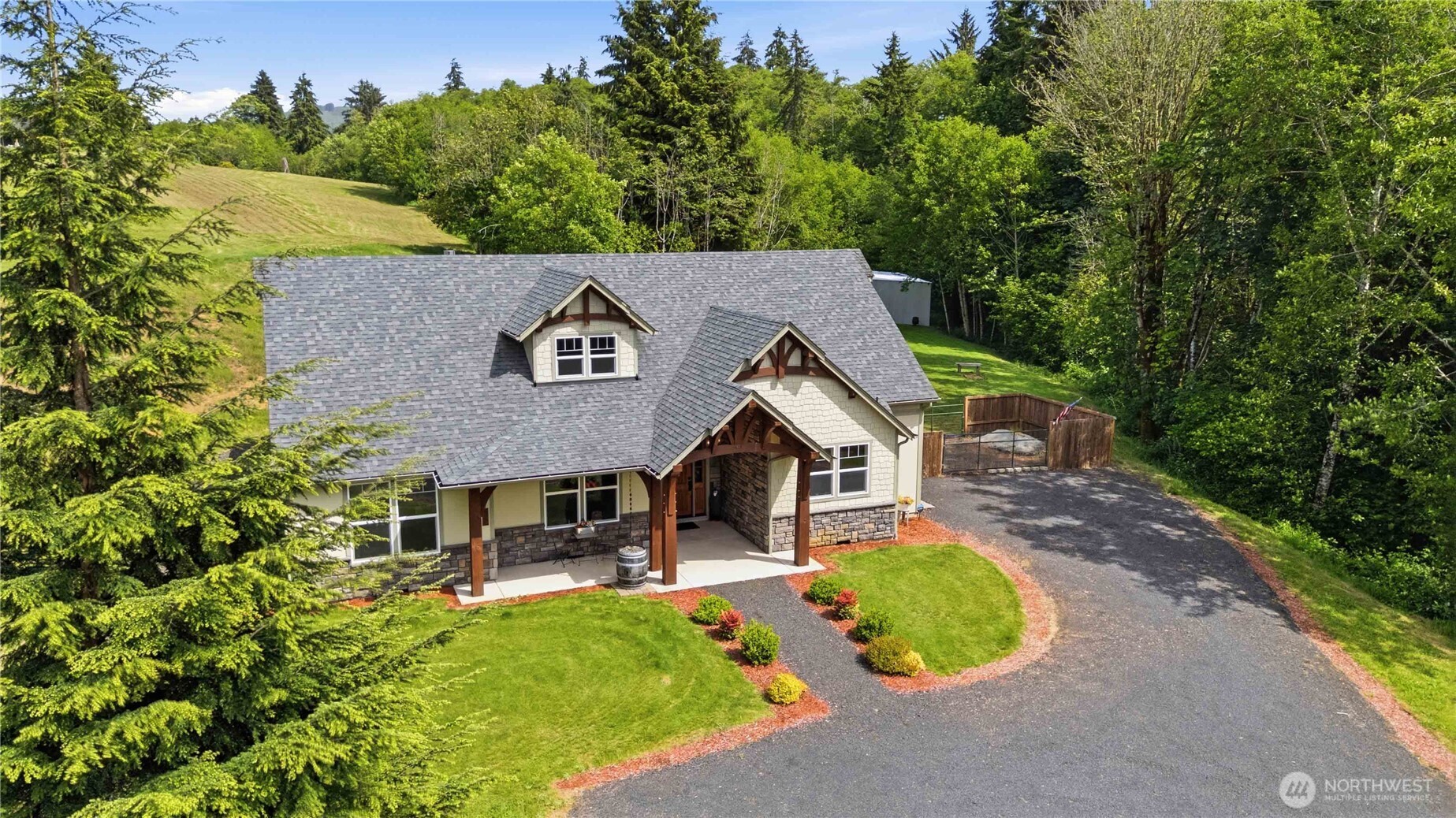 Tucked away on 6.2 private acres with a stream, river views, and the kind of peace that’s hard to find, this custom-built 2020 home is truly A Dream to Come Home To! Offering 3 bedrooms, 2.5 baths, plus a spacious upstairs bonus/entertainment room with its own half bath, this home was designed for both comfortable everyday living and effortless entertaining. From the moment you step through the stunning timber-framed entry with gorgeous tongue-and-groove detail, you’ll feel the craftsmanship and warmth that make this home stand apart. The gourmet kitchen is a dream for anyone who loves to cook or gather—featuring a massive island, double oven, commercial-quality cooktop, huge pantry, and beautiful custom granite, cabinetry, and lighting throughout. Two propane fireplaces with custom brickwork and mantels create cozy gathering spaces, while the oversized laundry/mud room and abundant storage throughout add practicality to the beauty. Step outside to your large covered back patio with custom timber accents overlooking a peaceful, incredibly private backyard perfect for morning coffee, evening gatherings, or simply soaking in the quiet. Need space for hobbies, equipment, or toys? You’ve got it—featuring a 24x36 shop, 20x40 equipment building, RV cover with sewer dump, and fenced garden area. If “coming home” should feel like an escape then look no further.
