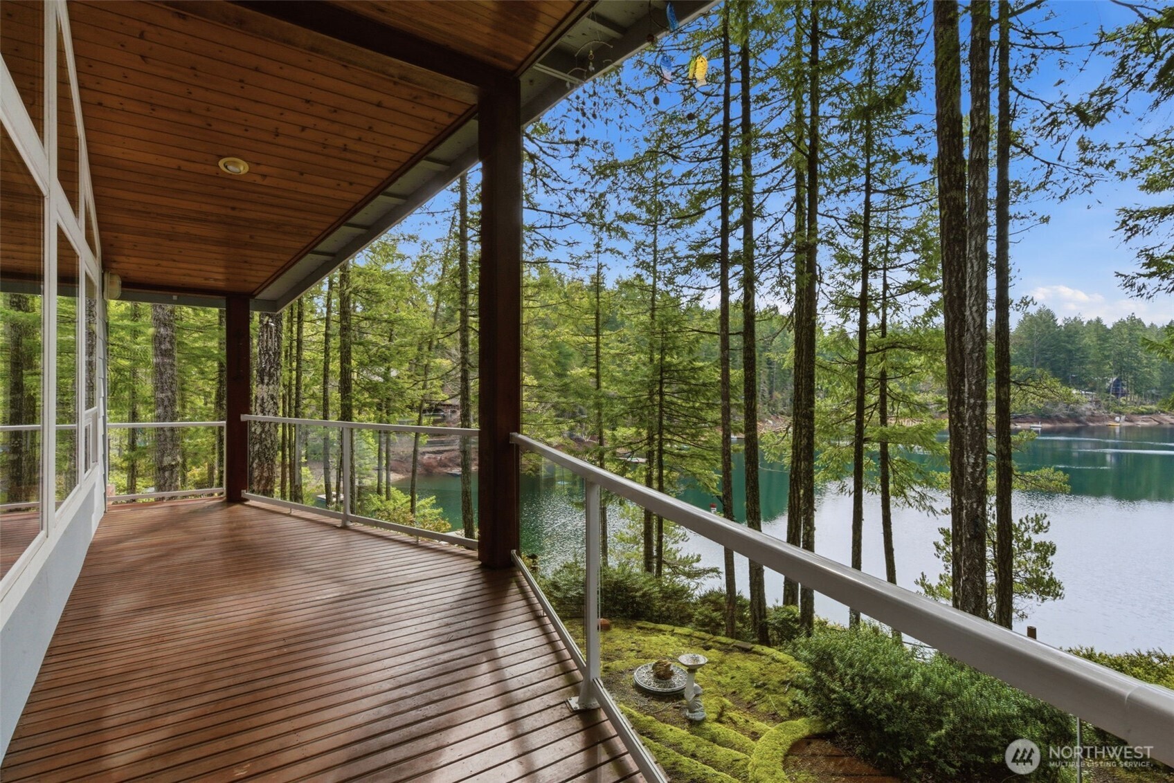 Escape to your own peaceful Northwest retreat. This active Airbnb sits on 2 lots on a private spring-fed lake stocked annually with trout and also offers exclusive access to the Hood Canal for year-round outdoor fun. Then cozy up next to the wood burning fireplace. This charming home is surrounded by lush forest and serene natural beauty. Storybook moss-lined terraced stone pathways wind through the forested landscape, leading you down to your private lakefront, creating a magical setting for fishing, relaxing, and enjoying the outdoors. Rare opportunity to own a tranquil getaway with both lake and canal access in one unique property.