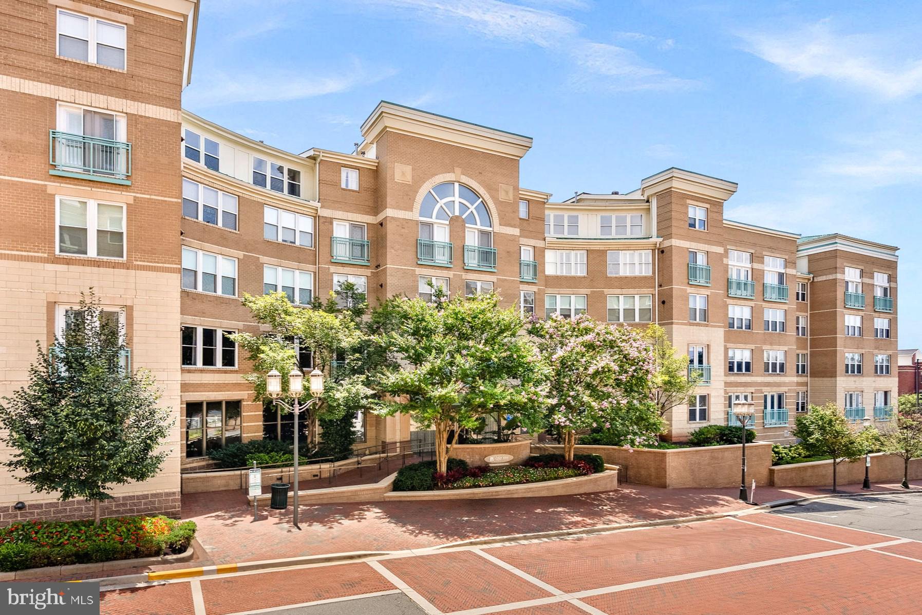 Welcome to this beautifully maintained two-level condo featuring 2 bedrooms, 2 full baths, and a dedicated office, ideally located in the heart of Reston Town Center. Upon entry, you are welcomed by an open-concept kitchen with maple cabinetry and a breakfast bar that flows seamlessly into the dining area and spacious living room, complete with a cozy fireplace and access to a private balcony overlooking the community outdoor pool, while the top-floor setting offers lovely views of the surrounding town. The main level also includes a versatile office, a well-appointed primary suite with a walk-in closet and en-suite bath with tub/shower combination, and a conveniently located laundry area with a recently updated dryer. Upstairs, a bright and airy second-level suite provides abundant natural light, a generously sized closet, and a full bath, making it ideal for guests or additional private living space. This unique unit conveys five parking spaces and two storage rooms, all conveniently located near the elevator, and offers secure building entry along with access to premium community amenities including an outdoor pool, fitness center, concierge service, business center, and party room. Situated in one of Reston’s most convenient residential centers, this home provides exceptional access to shopping, dining, entertainment, parks, trails, and Metro, offering a vibrant, low-maintenance lifestyle.