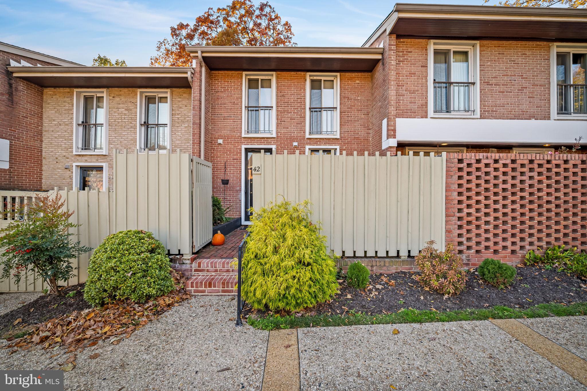Sunset views from this 18 ft west facing townhome  in Cross Keys.  .This cheerful home has been meticulously maintained and updated & is warmed  by a fireplace which is flanked by bookshelves in the living room.   Fresh and clean space.  The kitchen boasts granite countertops and white cabinetry and both baths have been  updated.  An attractive deck off the living room overlooks the trees - perfect for bird watching and nature lovers.  The  enclosed brick patio in front of the home is private.   Washer/dryer in unit and assigned parking make this space a pleasant place to call home.All roofs in the community have been replaced.Come enjoy the vibrancy of the newly revitalized Cross Keys with many fine dining options and attractive shops!  Take advantage of the 3 pools, walking trails and so much more.  Incredibly convenient location.woodburning fireplace "as is"