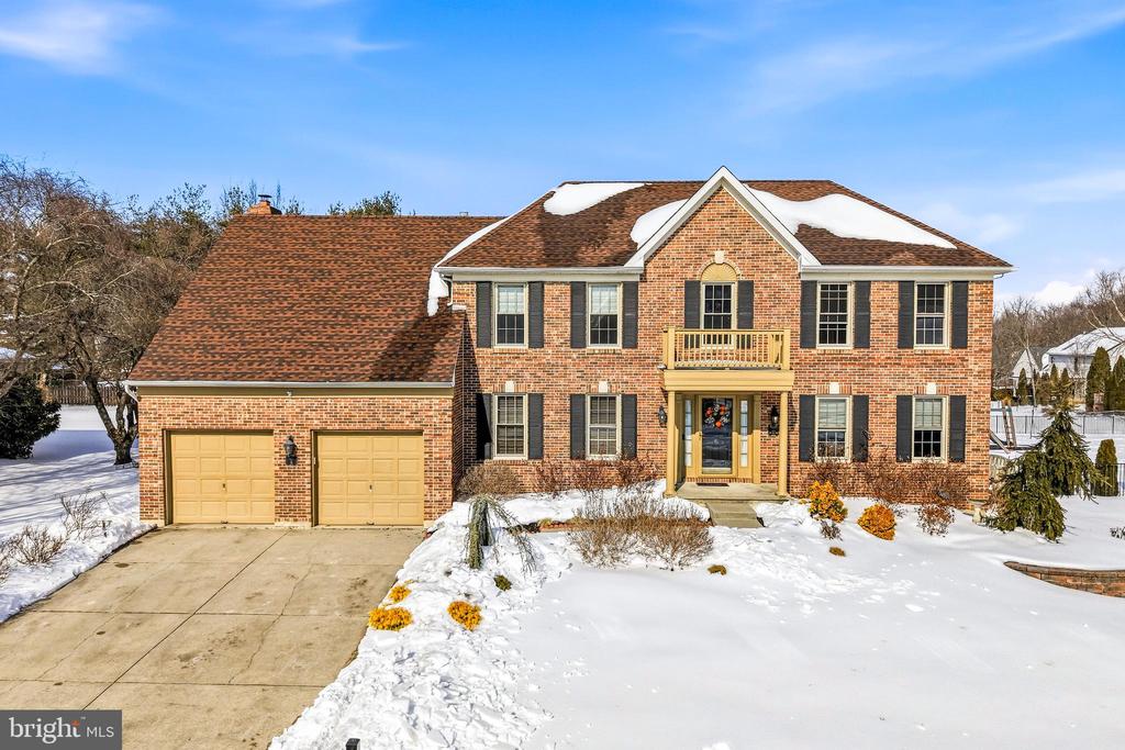 Welcome to this beautifully maintained brick-front Colonial located in desirable Spring Valley Estates. Step inside to a dramatic two-story foyer and enjoy newer hardwood flooring throughout the main level. The heart of the home is the brand-new custom kitchen, perfectly positioned for both everyday living and entertaining. The main level also features a private office, formal dining room, laundry room, powder room, and a spacious family room with gas fireplace, plus a bar/living room area ideal for gatherings. Just off the back of the home is a large enclosed screened in porch with skylights, offering year-round enjoyment and views of the extended deck and expansive fenced-in  backyard with a Basketball court. The upper level boasts a generous primary suite with an ensuite bath, along with three additional bedrooms and a full hall bathroom. The finished basement provides valuable extra living space, including an area that can easily serve as a fifth bedroom, home office, or flex space. Additional highlights include a two-car garage, fresh paint and carpeting, and a radon mitigation system. This home offers space, updates, and functionality — all in one of Mount Laurels most sought-after neighborhoods.