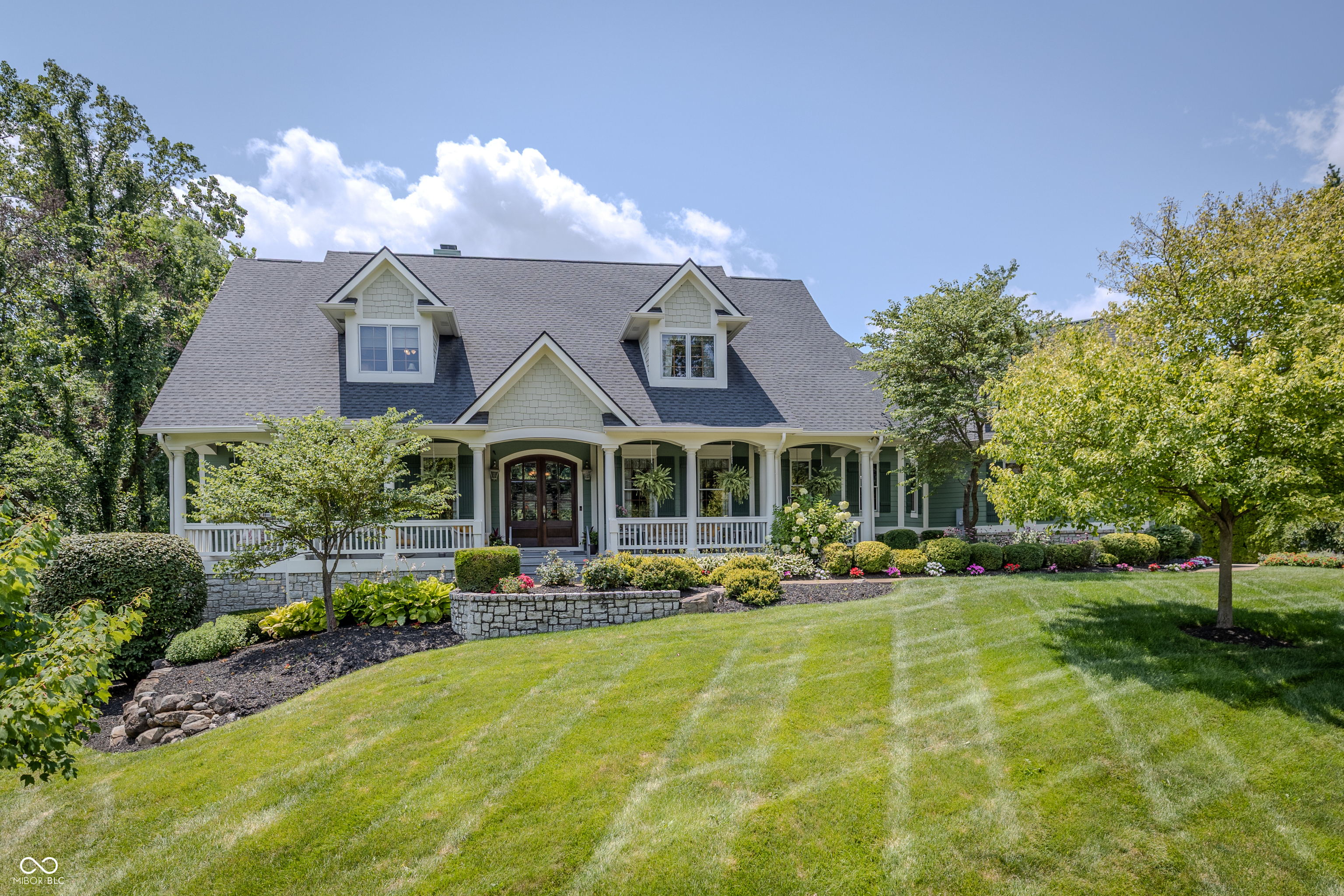 Tucked away on a private homesite, this exceptional custom estate offers a rare blend of sophisticated design, resort-inspired amenities, and effortless everyday living. Thoughtfully curated for both grand entertaining and quiet relaxation, the home showcases timeless architecture, expansive living spaces, and impeccable craftsmanship throughout.    At the center of the home is a stunning gourmet kitchen featuring premium appliances, double ovens, a custom range hood, an oversized center island with prep sink, and seamless flow into the spacious great room. The open design creates an elegant and inviting setting for both intimate gatherings and larger celebrations.    With six generously sized bedrooms and six full baths plus a powder room, the home provides exceptional comfort and privacy. A dedicated fitness studio enhances daily wellness with its adjoining steam shower and private sauna, creating a true spa-like retreat at home.    Step outside to a backyard designed to rival a private resort. A sparkling pool with a dramatic waterfall feature anchors the outdoor living space, complemented by areas for dining, lounging, and entertaining. A tranquil pond with fountain, mature landscaping, and the private setting create a peaceful backdrop rarely found.    Offering over 7,500 square feet of refined living space in one of Fishers' most desirable locations, this remarkable residence delivers the perfect balance of luxury, comfort, and privacy.