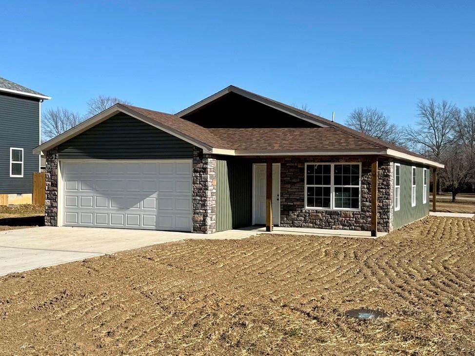 New-Construction Ranch Home in El Dorado Springs:This new-built home, located in a beautiful neighborhood on the south side of El Dorado Springs, will be ready for its first owner in January 2026.  The 1,401 sq ft home sits on a level .26-acre lot surrounded by a neighborhood of newer homes.  The maintenance free exterior showcases an attractive combination of siding and stone and accented by a front patio and a back BBQ/coffee patio. The main living space is a combination of the living room, dining room, and kitchen that is perfect for entertaining and allows for tons of natural lighting with 2 west-facing windows and 3 south-facing windows. The custom cabinets, with soft-close doors and drawers, granite counter tops, kitchen island, LED lighting, and new black appliances make this a top-tier and attractive kitchen.  There are 3 bedrooms and 2 bathrooms with one bathroom ensuite to the master.  A 2-car garage is attached.  This home has no steps, a 1-year builder’s warranty, low maintenance, and a perfect location for walking, biking, and quick errands to town.  Call today and schedule a private showing as the final touches are being finished on 1803 S Elm St in El Dorado Springs.