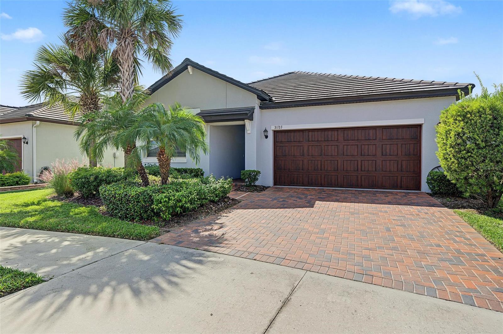 PREMIUM CUL-DE-SAC AND CONSERVATION LOT!!! Medley Active Adult for those better than 55 years young presents an exceptional lifestyle just beyond the confines of your home. As a resident, you'll enjoy exclusive Clubhouse access with a full calendar of events daily! You will also enjoy a grill & bar, heated pool w/cabanas, ballroom, billiards room, card room, state of the art fitness center, pickleball & tennis courts, bocce ball, yoga, bingo, card games, line dancing and private active adult events. PLUS included in your HOA is a 15-acre lagoon membership w/soft, sandy beaches including a swim-up bar, kayaking, paddleboarding, obstacle course, waterslides, corn hole games, and tons of community events! Be sure & invite friends or family to come along with you as you may gift them passes or pay a deeply discounted rate! There is also a BRAND NEW TIKI HUT COMING SOON along with another set of amazing amenites! This beautiful home will please even the most selective buyers! Comprised of 2 spacious bedrooms, 2 full baths, and bonus room that could be used as an office or den ALSO INCLUDED IS CROWN MOLDING THROUGHOUT THE MAIN LIVING AREAS. Primary Suite includes ensuite bath, dual sinks, walk-in shower and Walk-in Closet to keep you organized, ceiling fans to keep you cool. Spacious Laundry room opens into Primary closet which opens into Primary bath for your convienience. Your new home also has GRANITE countertops throughout, stainless appliances, walk-in pantry and abundant cabinetry. Sliding glass doors lead to your large covered SCREENED & TILED Lanai with wonderful CONSERVATION view. Also included is a tiled roof plus a pavered driveway! Gorgeous curb appeal on this block home with a 2-car garage WITH HANGING STORAGE RACKS. As you step inside, you'll be greeted by a seamless flow of open living spaces, making it ideal for both relaxation and entertaining. Get ready to make memories that will last a lifetime! Your dream home awaits; you will be enjoying the CAREFREE FLORIDA RESORT LIFESTYLE in your new home as quickly as you are able to move in! High-speed (ULTRAFI) internet, premium cable, yard maintenance & exterior painting are included by the HOA. Situated in close proximity to premier shopping destinations, and an array of dining options, you'll find yourself immersed in a vibrant community that strikes a perfect balance between exclusivity and convenience. Ride your Golf Cart to the Clubhouse, Publix, Chick-fil-a, Starbucks, Farmers Market and more right in the neighborhood! Close to Advent Health Hospitals, BayCare Hospital, Florida Medical Clinic, Wire Grass Mall, Tampa Premium Outlet Mall, Krate at the Grove, Sam's Club, Costco, Golf Courses & Movie Theater. Easy access to I75, 275, Tampa International Airport, Downtown Tampa and Florida's amazing beaches. CDD IS ALREADY INCLUDED IN TAX AMOUNT.