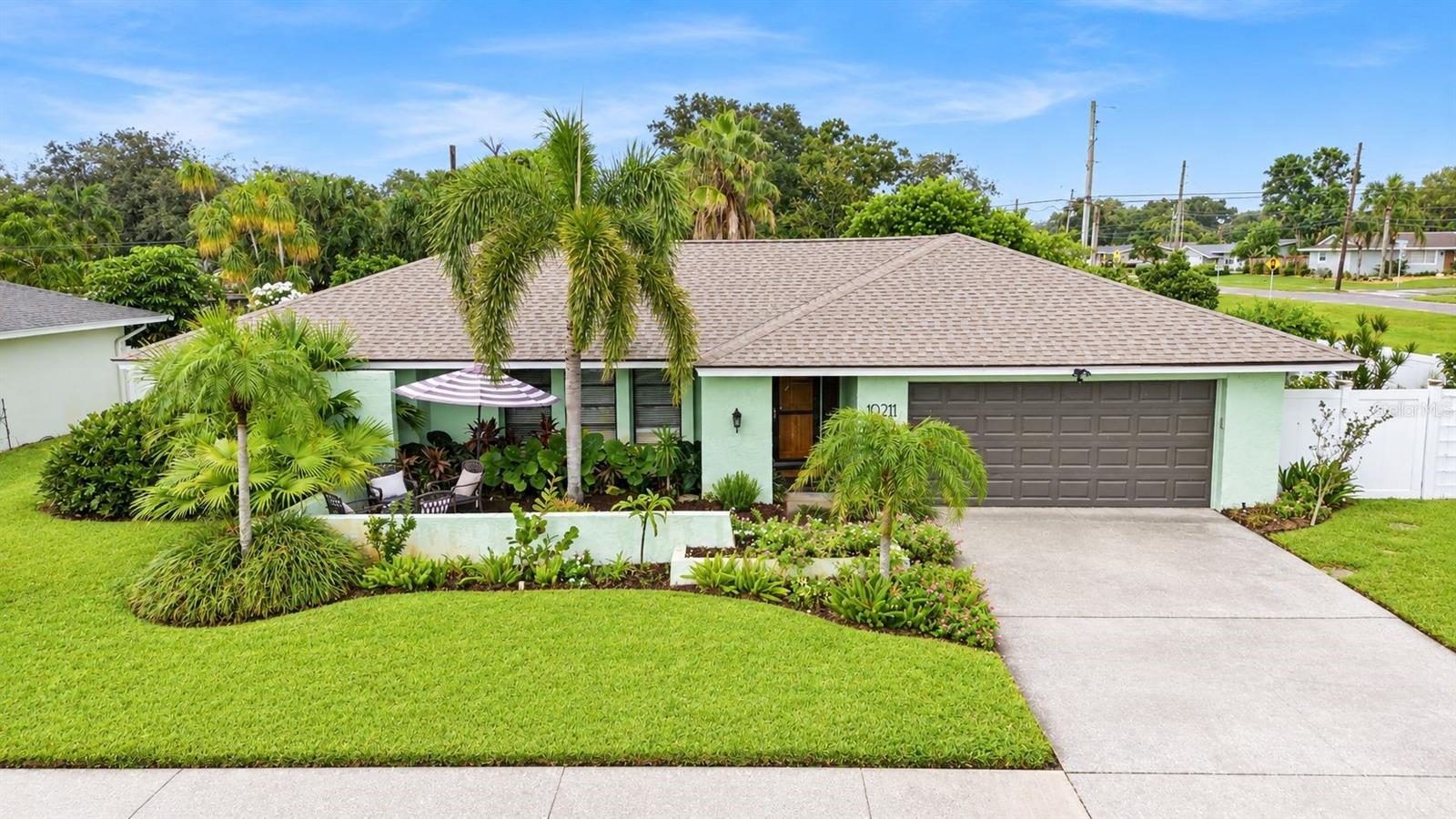 Welcome to this aesthetically soothing, updated 4-bedroom, 3-full-bath nest, offering the ultimate blend of modern luxury and timeless Florida living. Located in a desirable, low-HOA community where no flood insurance is required, this property is designed to impress and soothe from the moment you arrive.Step inside to discover versatile living spaces and quality design elements at every turn—down to the brand-new door knobs, updated plumbing fixtures, fresh paint and newer appliances. The thoughtful layout features an open living and dining room space, with an additional family room just through the kitchen or conditioned sun room.  The primary bedroom is just off the dining area.  Leaving the other three adjacent to the living spaces with a convenient Jack-and-Jill bathroom between bedrooms 2 and 3.  The 4th bedroom offers a lovely slider door with views and access to the pool patio. The 3rd full bathroom also has pool deck access, to buffer any pool goers and wet feet.   The chef-inspired kitchen is truly at the heart of the home.  With two breakfast bars, granite counter tops, and a new refrigerator, you’ll enjoy a lovely sunrise view just beyond the kitchen sink, overlooking the sunroom and pool deck.   The pass-through breakfast bar, from the kitchen into the sun room, makes for great entertaining set ups.  You will be able to embrace the Florida lifestyle in your light-filled sunroom featuring panoramic windows that frame lush tropical views. Step outside to your private, screened-in pool oasis, perfect for weekend lounging or memorable gatherings. The fully fenced backyard is a tropical paradise complete with an electrically sourced shed, classy landscaping and flourishing fruit and avocado trees. Say hello to organization in the jaw-dropping luxury laundry and mudroom. Outfitted with custom built-ins, abundant storage space, extra counter space, a convenient utility sink, and a bonus 2nd refrigerator, with access to the garage, it's a true functional masterpiece. Wrap up your evenings by taking in gorgeous Florida sunsets from the newly finished front patio or Don't miss the opportunity to own this uniquely curated, move-in ready sanctuary.