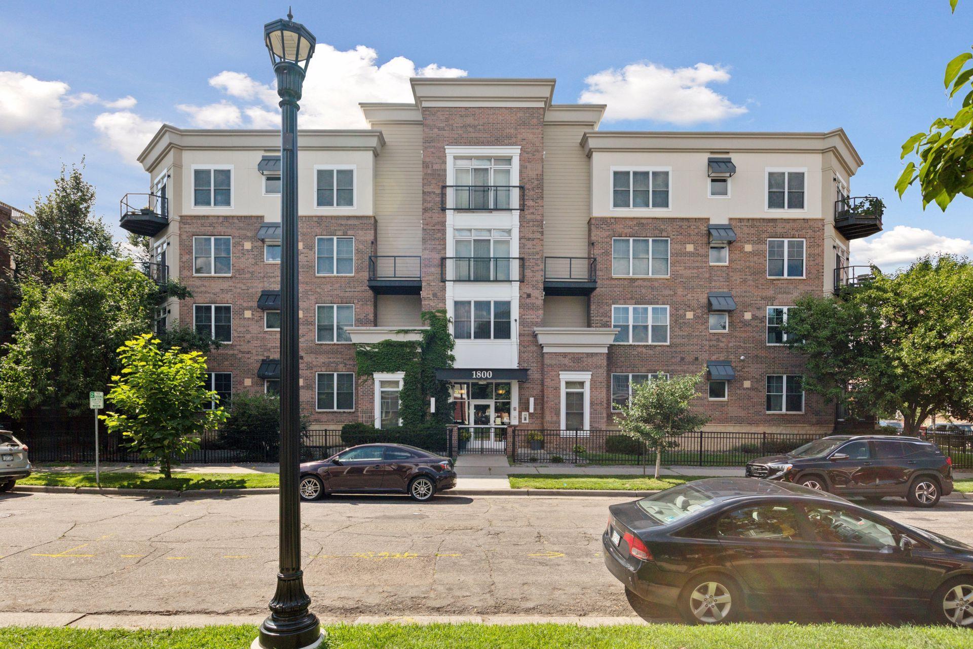 You will love this oversized CORNER UNIT, 1 bedroom 1 bath condo in Stevens Square. Great location for walkability to everywhere. Loring Park, Downtown, coffee shops, Convention Center, Sculpture Gardens. Easy to get onto the highway. This is a newer condo building in the area built in 2004. High ceilings, heated garage space, workout room, bike storage room, common patio area with grill and picnic bench, party room, nice lobby space, large storage room , close to your unit. Maple hardwood floor throughout, except for the bedroom, which has nice carpeting. This unit is very clean, nice paint colors. Large in unit laundry with storage racks. good sized coat closet. Large entry area, area for a work station or desk, formal living room with a wall of windows. This corner unit is very bright inside great natural light. Informal dining area with sliding door to a nice private balcony up in the tree tops. Open kitchen with a large island for seating. Tiled backsplash, stainless appliances, the roof is newer in last 3-4 years. New furnace 2024, new A/C in 2023, new dishwasher 2024, Wash machine in 2020,  toilet 2021. This is a very well cared for condo unit and in move in condition. Low monthly dues compared to many other condos.