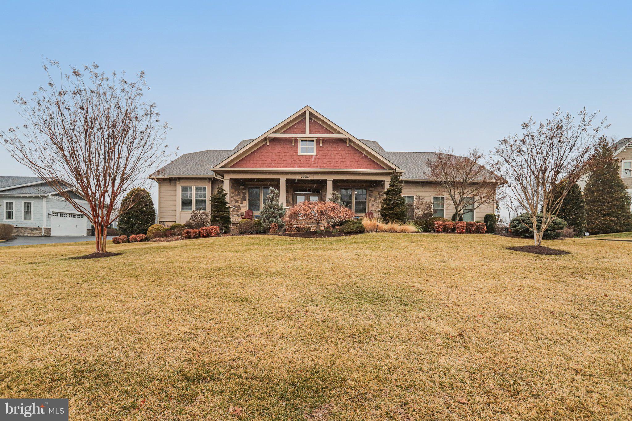 Welcome to this exceptional residence in The Grant at Willowsford, where luxury and main-level living come together beautifully. Built by Arcadia Homes and offering 6,388 square feet of thoughtfully designed living space on a .86-acre lot, this home features high-end finishes, timeless architectural details, and a seamless indoor-outdoor lifestyle.Designed for both grand entertaining and comfortable everyday living, many of the main living areas open to a private rear courtyard. Highlights include designer paint, custom window treatments, wide-plank flooring, 10’ ceilings, and abundant natural light throughout.A welcoming front porch leads to an inviting interior featuring a cozy sitting room and a formal dining room enhanced by a stunning climate-controlled wine cellar, creating a unique and sophisticated entertaining experience.The gourmet kitchen is a chef’s dream, showcasing premium cabinetry, Sub-Zero, Wolf, and Asko appliances, a large center island, custom pantry built-ins, and a bright breakfast area. The adjacent great room features a dramatic floor-to-ceiling stacked stone fireplace, built-in window seats with storage, and beautiful outdoor views.The private owner’s suite is tucked into its own wing and offers deck access along with a spa-inspired bath featuring heated floors, soaking tub, frameless shower, dual vanities, and a spacious walk-in closet. Two additional main-level bedrooms each include en-suite baths.The expansive lower level is designed for entertaining and flexibility, offering a large family room with gas fireplace and built-ins, a recreation area, and a full-service bar complete with dual-zone wine refrigerator, dishwasher, beverage refrigerator, microwave, and ice maker, plus dining space. This level also includes a generous en-suite bedroom with walk-in closet, a media room, half bath, private office and extensive storage.Additional features include a main-level laundry room and a three-car side-load garage.Outdoor living is equally impressive with professionally landscaped grounds, a private level fenced backyard, paver patio, hot tub, and deck.Residents of Willowsford enjoy resort-style amenities including two clubhouses, pools, a fitness center, miles of hiking and biking trails, fishing pond, dog park, zip line, and a working farm. This award-winning community offers the charm of rural living with convenient access to Dulles Airport, major commuter routes, Metro, shopping, dining, and local vineyards—approximately one hour from Washington, D.C.Schedule your private showing today.