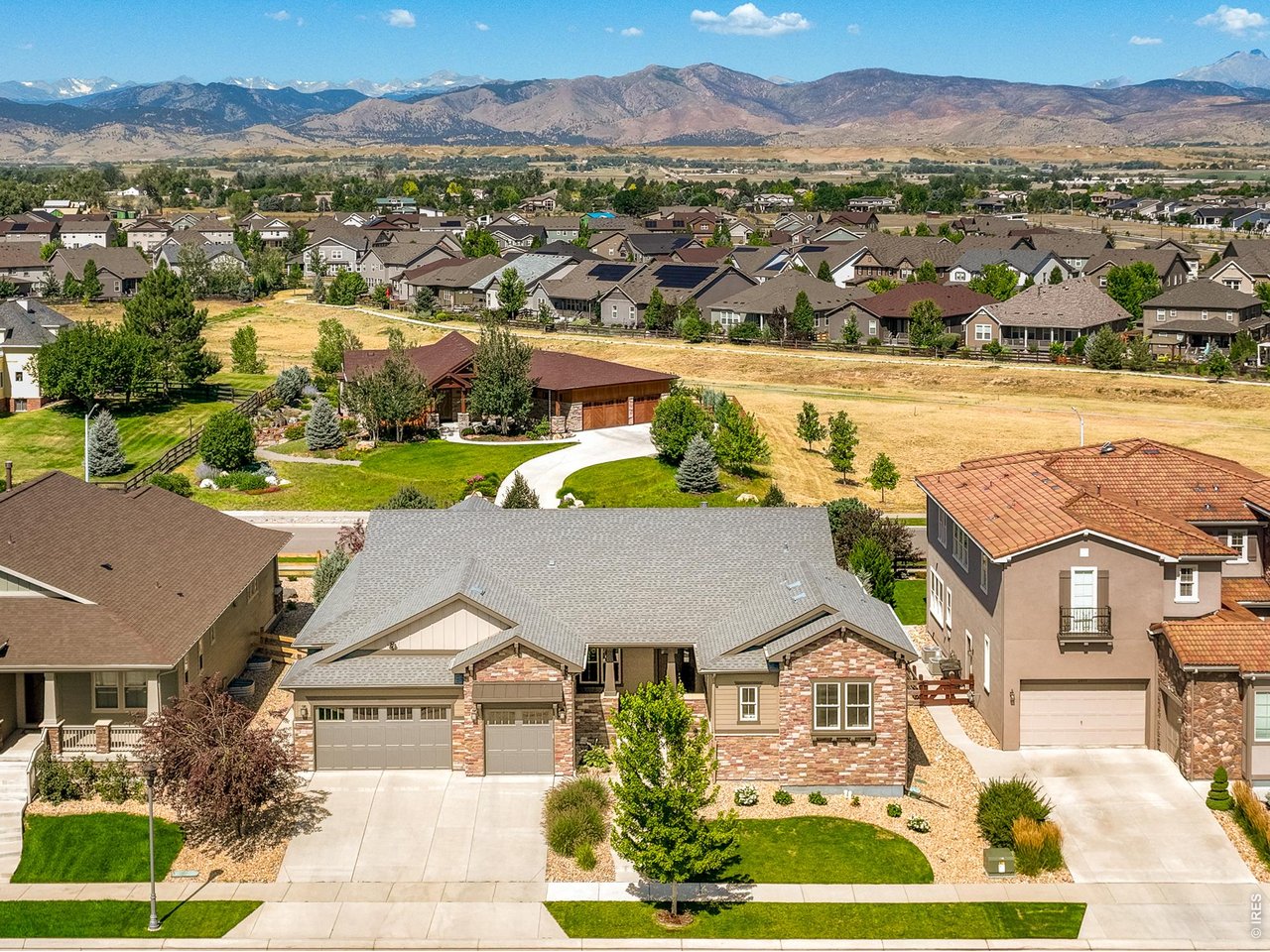 Stunning main-level livingn and move-in ready in the coveted Somerset Meadows neighborhood! Offering beautiful design, effortless livability, and an absolute dream of a backyard in one of the Longmont's most desirable neighborhoods. 2309 Picadilly pairs the ease of main-level living with exceptional scale, mountain views and a remarkable level of thoughtful upgrades. This semi-custom ranch-style home is beautifully updated, light-filled, and oriented toward the mountains.The great room is framed by expansive windows and anchored by a gorgeous stone fireplace, with the kitchen and dining area flowing naturally together. Wide-plank wood floors, quartz surfaces, Hunter Douglas motorized shades and custom closets add polish and elegance throughout. The main-level primary suite features west-facing mountain views, a five-piece bath, generous walk-in closet, direct access to the laundry room and a dedicated heating and cooling zone. Two additional ensuite bedrooms offer flexibility for guests or office space.The lower level adds another layer of living with 9-foot ceilings, daylight windows, a family room, wet bar, dedicated gym, full movie theater with recliner seating, second laundry, storage and upgraded electrical. Outside, the fully fenced backyard has been extensively renovated with new landscaping, sprinkler system and outdoor living areas. The three-car garage features epoxy flooring, new insulated garage doors with oversized windows, a side entry door and 220V EV charging. Additional improvements include a new roof, fresh exterior paint and expanded HVAC capacity. Polished, spacious and exceptionally complete, 2309 Picadilly offers thoughtful upgrades that make a meaningful difference in everyday living. LIVE BOLDER, LOVE BOULDER!