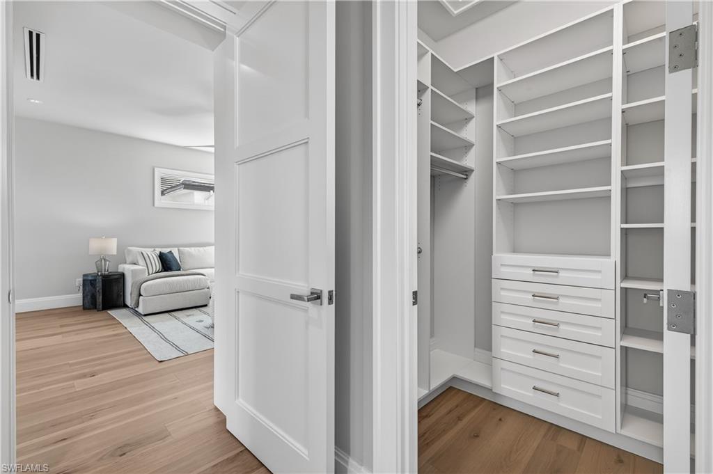 Walk in closet featuring light wood-type flooring