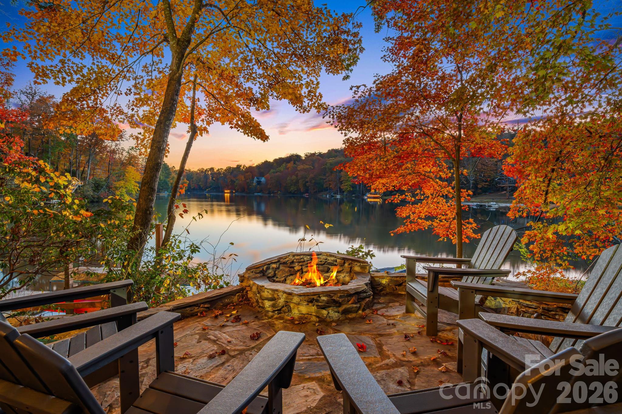 True to its name, Tranquility Lake House offers a rare blend of absolute serenity and powerhouse investment performance. Tucked away on a quiet, non-motorized section of Bald Mountain Lake in Lake Lure, this premium waterfront estate is a turnkey short-term rental managed by Carolina Mornings. The estate features two distinct living structures that comfortably sleep twelve guests. The main home is an open-concept mountain oasis anchored by soaring ceilings, warm wood finishes and a magical stone fireplace. Moments away, the carriage house suite over the garage and game room offers premium privacy. Outside, expansive decking leads to a private dock where days are spent kayaking crystal-clear waters and watching mountain sunsets. Owners and guests enjoy full access to Rumbling Bald Resort's two championship golf courses, private beach, pools and tennis, all set against a backdrop famous for its role in the classic film, Dirty Dancing.
