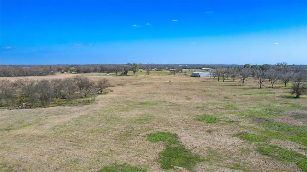 Grass production is here! Over 112 acres of good Hopkins County sandy soil property located at the corner of 2 state maintained FM highways and CR 3369 in the Greenwood area and only minutes from I30. Property has road on 2 sides with approx. 4500' of good road frontage. This ag exempt property is fenced with multiple cross fences, shade and ample surface water for your livestock operation. The bonus of  a 92x100 all metal building for feed and equipment  is in place and ready for your operation. There are several smaller pens with loafing sheds that would be great for small animals, horses, exotic operation or raising calves. another hay barn is located on the west side of property with an entrance from CR 3368.  The improved pastures are coastal, rye, Bermuda and native grasses for great grazing and production ability. The property has been used for livestock and hay production. There are several small stock ponds as well as Greenwood Creek at back of property. There is several home building spots. There is NO FEMA floodplain or NO known restrictions on this property allowing buyer multiple opportunities including investment, development or maintaining current ag productivity. This property is centrally located between the great communities of Sulphur Springs, Mount Vernon, Winnsboro and only a few minutes from lake Cypress Springs for great restaurants, traditions and festivities. Approx. 90 minutes east of DFW metroplex. Utility providers - Farmers  Electric CO-op and Cypress Springs SUD for water. NEW SURVEY!