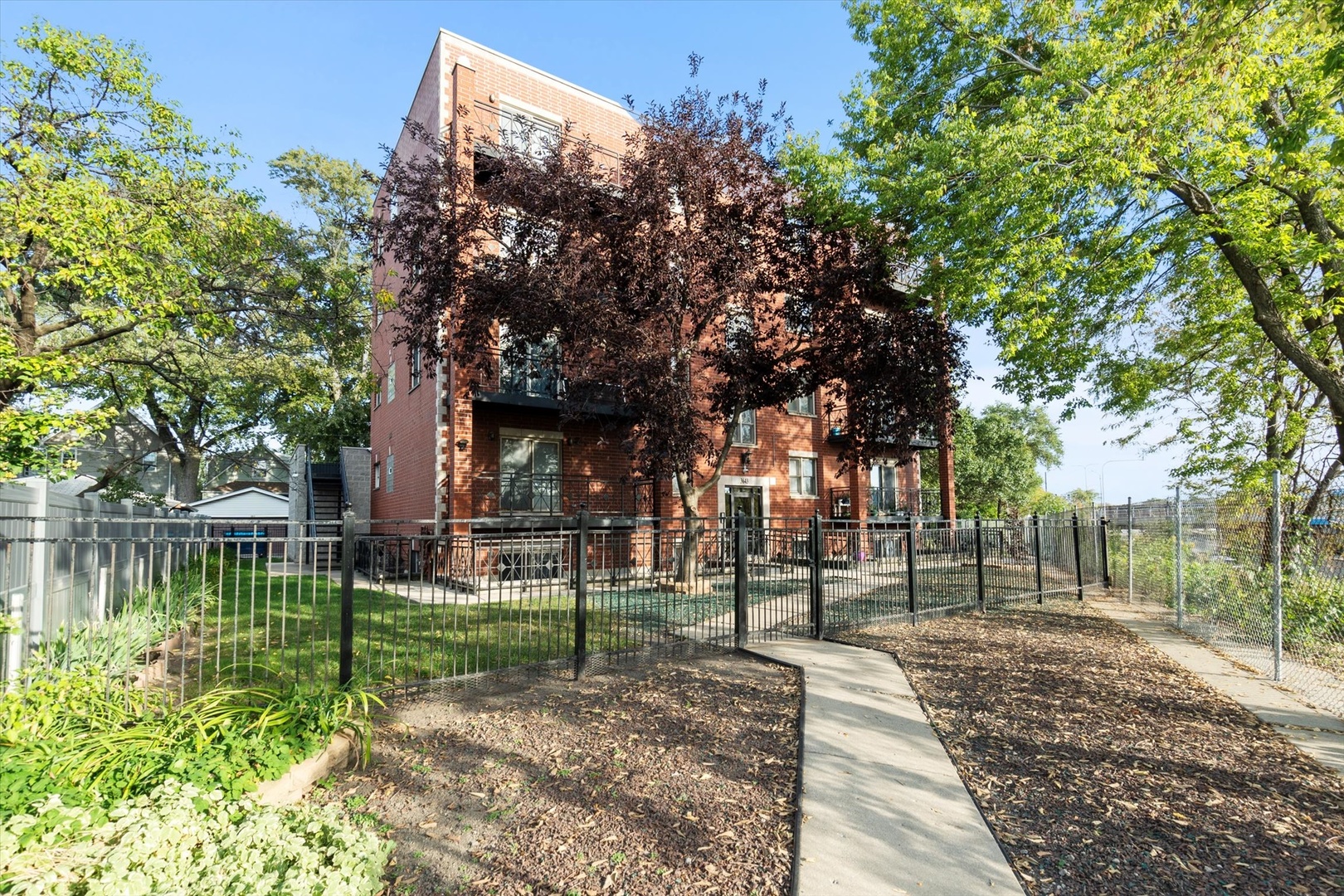 Super bright duplex offers over 2000 square feet of living! Situated in a perfect location, this condo has hardwood floors throughout and offers 3 bedrooms, 2.5 bathrooms plus a large family room! The main level is one large great room featuring your kitchen, living and dining areas as well as two separate balconies plus a half bath. Enjoy the outdoors or the quiet indoors with the unit's triple pane glass! Refreshed kitchen has 42" cabinetry, quartz counters, a huge island, stainless steel appliances and is such a wonderful entertaining area! The living area has a gas fireplace for those chilly nights. Upstairs, you'll find all 3 bedrooms on the same level.  A flexible lofted space can be used as home office, family room or workout area. The true en suite offers a custom walk in shower. There are 2 garage spaces included, as well as one exterior parking space.  The fenced-in common grounds are wooded and include tons of space to roam around Newer 1,000 sq ft common Trex deck spans length of the entire building.  Easy access to I 90/94Walk to the CTA/ Blue Line, Metra, LA Fitness, Jewel, Disney School, Independence Park, Murphy School, Athletic Field Park with playground, field house, tennis, basketball courts and close to Independence Park. Come see this before it is gone!