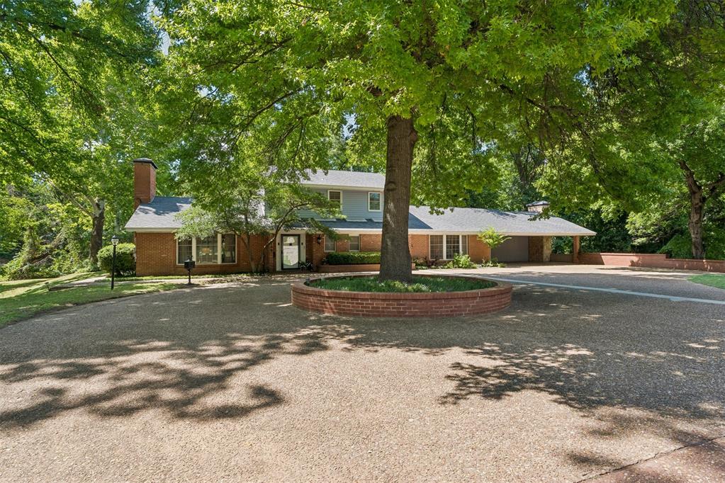 Fabulous location in the McKinley school district and close to OU campus! On 3/4 acre, the setting feels worlds away, backing up to a wooded creek with mature trees and peaceful views. Just steps outside, you will find a red bridge leading to the neighborhood pool nestled in the valley below. Only a few neighbors enjoy the perks of membership in the Lakewood Pool Association! Inside, the home is bright, inviting, and full of natural light, with thoughtful updates throughout. The spacious living room centers around a cozy fireplace and opens into a gigantic heated and cooled sunroom - an incredible flex space ideal for a garden room, entertaining lounge, or studio. The original owners even had a wedding in this memorable space! Designed with entertaining in mind, the oversized kitchen offers extensive counter space, butcher block countertops, and abundant cabinetry. The large laundry room and adjoining project room provide functionality rarely found in homes of this period. The downstairs primary suite offers privacy and comfort with substantial closets and an ensuite bath featuring double vanities and a huge bathtub and shower. Upstairs, two spacious bedrooms have newly refinished hardwood floors and expansive walk-in closets. On the first level, a fourth bedroom or dedicated study includes a walk-in closet, built-in bookcases, a window seat, and its own private full bath. One of the home’s most unforgettable features is hidden just down the spiral staircase: a finished walkout basement complete with a fireplace, bar with plumbing, refrigerator, and vintage style. It’s the ultimate game room, music room, media lounge, or comfortable place to gather during Oklahoma storm season. Much of the memorabilia stays with the sale of the home. This is such a fun space! After a swim, head back inside to enjoy the built-in sauna! This home blends space, updates, setting, and character into a lifestyle opportunity unlike anything else on the market.