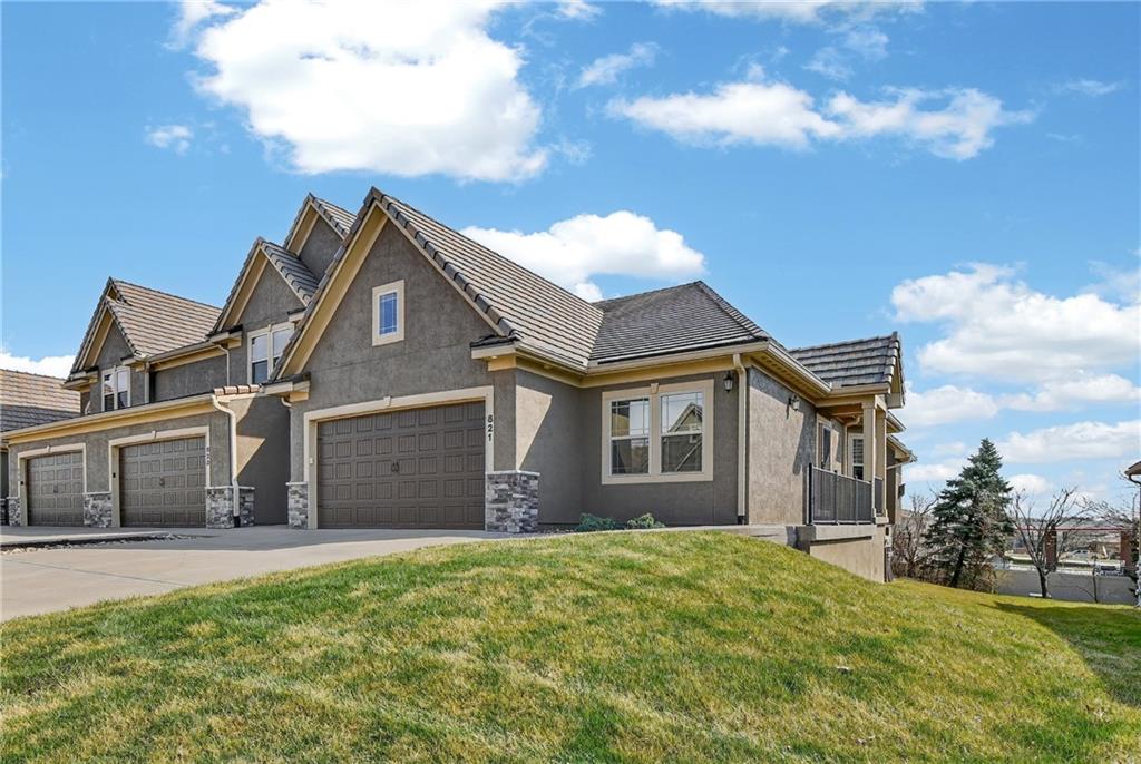 TRUE RANCH VILLA | CHAPEL RIDGE WOODS AT LAKEWOOD | MAINTENANCE-PROVIDED Discover refined main-level living in this 2019 built true ranch villa, perfectly situated in the Chapel Ridge Woods section of the master-planned Lakewood community. This "lock-and-leave" residence offers complete convenience with an HOA that manages lawn care, snow removal, and trash.The open-concept interior features an expansive great room anchored by a gas fireplace, flowing seamlessly into the kitchen and dining areas. The gourmet kitchen is a focal point, boasting an oversized granite island, custom painted cabinetry, and a walk-in pantry. Retreat to the primary suite, which includes a spacious walk-in closet, double vanity, and a modern walk-in shower.Property Highlights:Superior Build: Concrete & tiled maintenance free roof, stucco and stone-trim exterior, & high-efficiency insulation (R-49 ceilings R-19 walls). Main Level Living: Includes two bedrooms, two full baths, and a dedicated laundry room all on one floor. Equity Potential: The full daylight basement is already insulated and stubbed for a bath ready for your custom finish to add immediate square footage & value. Outdoor Space: Enjoy a large private deck overlooking the treed lot. Inground sprinkler system. World-Class Amenities: Full access to Lakewood’s 365-acre private lake, clubhouse, swimming pools, tennis courts, and walking trails.Experience the quality of a newer build with the established luxury of one of Lee's Summit's premier maintenance-provided neighborhoods.