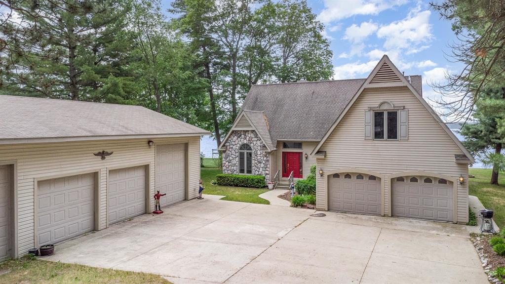 Custom Lakefront Home on Van Etten Lake - 2,894 Sq Ft of Quality and Comfort! A beautifully crafted 3+bedrooms, 2.5 bath custom home with a large bonus room offers luxury living on 120 feet of Van Etten Lake frontage. Designed with high-end finishes and energy efficiency, the home features a spacious main-floor primary suite with walk-in closets, skylights, a low-threshold walk-in shower and a connected solarium featuring a hot tub and workout space for a retreat feel. The gourmet kitchen includes granite countertops, an island with vegetable sink, dual disposals, pantry, desk area, wall oven, cooktop, microwave, and stunning lake views. A grand foyer, den/office, and family room with a custom oak fireplace, and laundry room complete the main level. Upstairs are two additional bedrooms with walk-in closets, a full bath, and a large bonus room suitable for a 4th bedroom or flex space such as a media room or hobby area. Built for comfort and efficiency, the home includes six-inch walls with chemical-free insulation, Low-E windows, 15‚  attic insulation, a programmable thermostat, central vacuum, water softener and ceiling fans throughout enhance year-round airflow. The beautifully landscaped yard features a stamped concrete patio, porch, deck, built-in grill, perennial gardens, underground sprinklers, and a dedicated plant irrigation system. The 120-foot steel seawall and 70-foot dock (negotiable) provide ideal easy access to the lake. A concrete driveway leads to a two-car attached garage and a pole barn featuring three spacious bays, a 30x38 heated and insulated workshop, and a 30x12 storage area. Includes 100 AMP and 220V electric service, gas force air heat, frost free water supply, an air-over-hydraulic in-ground two-post vehicle lift, a 220V air compressor, heavy duty overhead I-beam with rolling trolley and chain fall, and more! A finely built, well appointed lakefront home with style, function, and features designed to enhance your everyday life year-round!