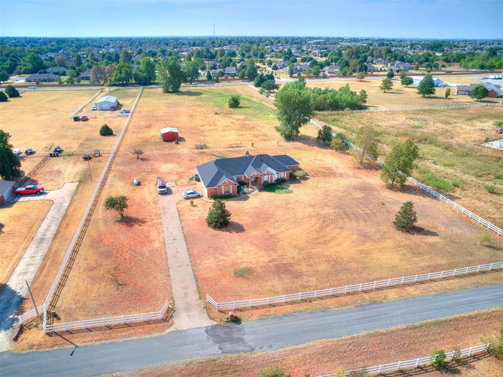 A peaceful rural feel on 5+ acres while staying close to city conveniences.  The property offers dual road access from the front road or from the back of the acreage via SW 59th St.  This updated home features a new roof, fresh paint and crown molding throughout,  new top-of-the-line pet and kid-friendly LVP flooring, new bedroom carpet,  new fans/light fixtures, new plumbing for the well and a newer pump and hot water tank. The open kitchen and living room create an ideal gathering place for family and friends. The kitchen offers extensive light oak cabinetry, plus additional light oak built-ins throughout the home for ample storage. The bedrooms are great size with plenty of natural light and open views of the property.  The laundry offers a utility sink and storage cabinets. Outside, enjoy a private ranch-style setting cross-fenced for horses with a barn/20x20 running shed.  If you have a travel camper, horse trailer, or any other type of  contraption, this property has room for it!  100 gallons of propane already filled and ready for the new owner! Come see for yourself and bring your vision to life!