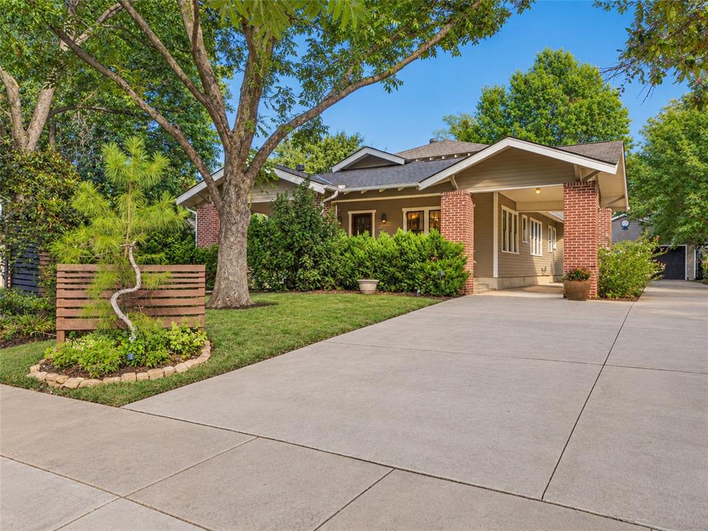 Welcome to a beautifully appointed Norman bungalow set on two lots where timeless character and thoughtful modern updates come together in an inviting, sophisticated setting. Ideally positioned near the University of Oklahoma and Lions Park, this distinctive home offers a wonderful balance of classic charm, comfortable living, and exceptional outdoor spaces. Inside, rich wood, ceramic and slate tile flooring set the tone, complemented by built-in bookshelves and a welcoming fireplace. The thoughtfully designed floor plan features two spacious living areas, two dining spaces, and a versatile bonus room ideal for a private office, study, or additional living area. At the heart of the home, the updated kitchen pairs timeless style with everyday functionality, featuring quartz countertops, large center island, pantry, gas range, refrigerator, and a new dishwasher installed in 2025. The outdoor living experience is truly exceptional. A fully fenced backyard unfolds into a peaceful, park-like retreat framed by a charming English garden and established garden beds perfect for cultivating fresh vegetables. Whether hosting friends around the grill or unwinding in the hot tub, this private outdoor setting offers an ideal extension of the home's living space. A detached two-car garage provides valuable additional storage and convenience. Numerous major improvements including a new central heat and air system and water heater in 2022, new roof, gutters, and north-side windows in 2023. With its distinctive bungalow character, beautifully updated interiors, mature outdoor setting, and highly convenient location near OU, parks, shopping, and dining, this exceptional Norman residence offers a rare combination of charm, comfort, and enduring appeal.