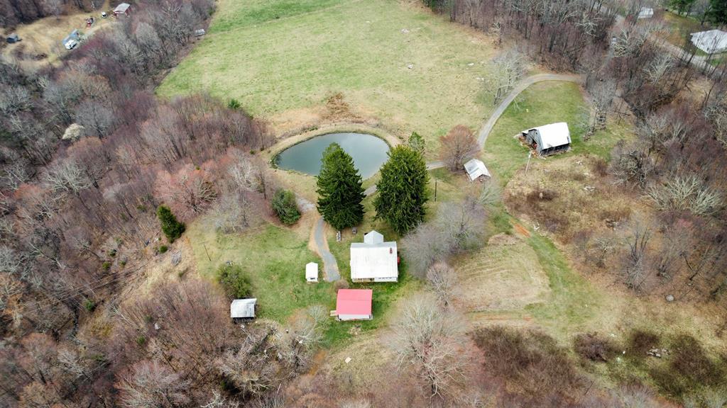 This secluded property features a Farmhouse with 4-bedrooms, 1 bath along with an old barn, outbuildings, springhouse and a beautiful view. It includes 60 acres of land, providing plenty of space for outdoor activities including gardening, bird watching, fishing, horse-back riding, ATV riding, hunting, and farming. In front of the house, there is a large pond that adds to the scenic surroundings. The pond is stocked with Bass and Bluegill. Hunter's paradise with Deer, Bear, & Turkey! Bring your horses along with all of your other animals and enjoy the beauty and seclusion this property has to offer.