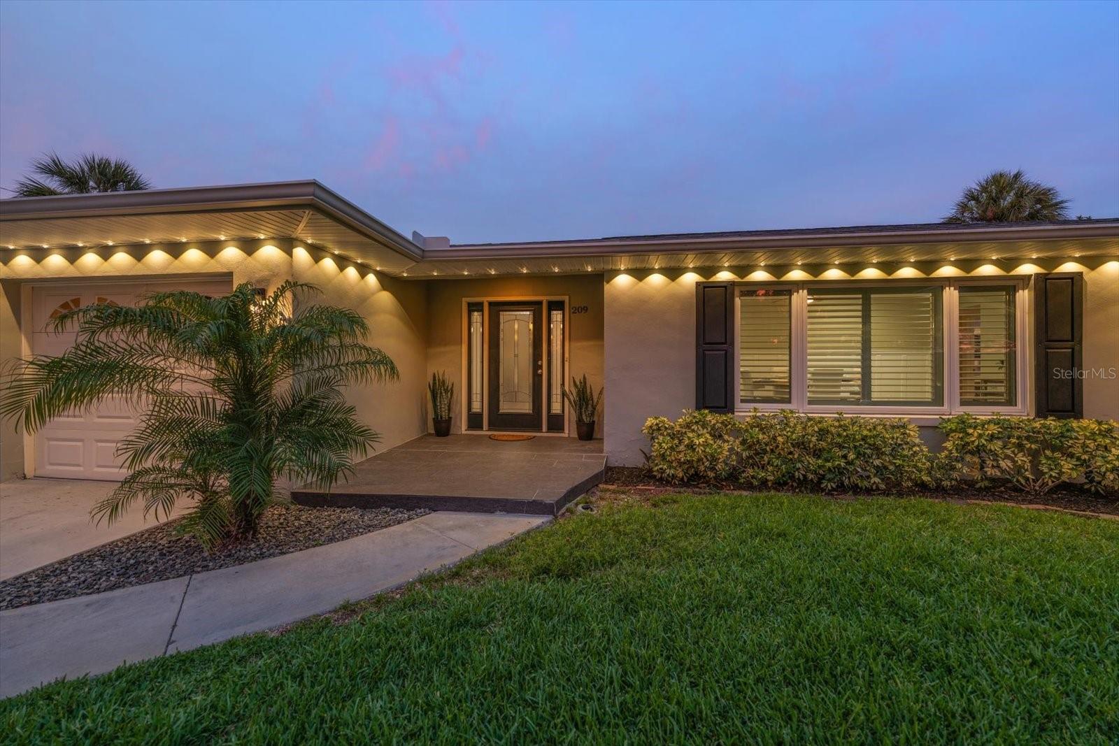 Refreshing! If you have been searching for that perfect mix of bright, airy, and effortlessly inviting, this beautifully updated home creates instant appeal the moment one enters. An abundance of natural light accents the open concept living spaces, highlighting attention to detail at every turn. Everyone will appreciate the versatility of the four-way split bedroom plan. Attractive finishes include bamboo and tile flooring, sliding barn door application, and classic board and batten wall treatment that blends perfectly with clean, modern minimalism so evident in this tastefully updated property. Unwind in the recent addition of the primary suite with high ceilings and transom windows. A separate exterior entry offers easy access to beautiful outdoor environs and a huge walk-in customized closet, spa like bath area with walk-in shower, and soaking tub provide privacy in a world of comfort.  Everyone enjoys the heart of the home-the kitchen! With tons of custom cabinetry, and gorgeous granite countertops, any chef will appreciate the spacious layout offering open space where one can share memorable culinary moments. Impressive large island is designed for effortless dining and adjoins the family room area. Enjoy the outdoor view through expansive windows that capture vibrant green manicured lawns. A gorgeous crystal-clear open pool takes center stage flanked by a separate patio perfect for alfresco dining or relaxing in the shade. Situated on an expansive lot, the property offers a significant side yard dedicated to parking your boat securely behind the fully fenced lot. High elevation, over 40+foot, out of any evacuation area, the Harbor Bluffs community is a very desirable neighborhood offering a lifestyle that few areas compare. Just minutes to pristine beaches, local dining and shopping, this neighborhood mirrors the ultimate coastal sanctuary where safety, style and location perfectly align. Don’t miss this one!