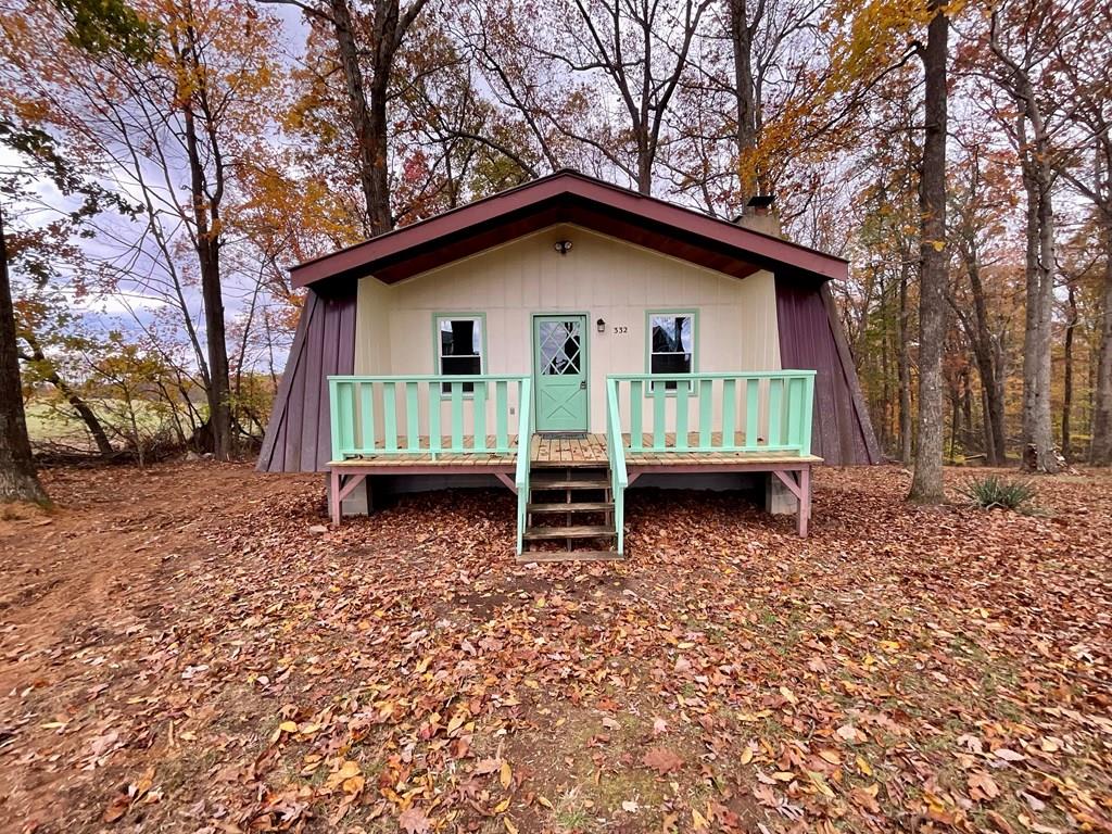 A charming cottage right off the Blue Ridge Parkway in Fancy Gap that has been given new life with new porch decking, new luxury vinyl plank flooring throughout, all new windows, new light fixtures, new kitchen cabinets, countertops, appliances and an island.  The walls have been painted a crisp, bright white, and the bathroom is all new, including new plumbing.  There are new digital baseboard heaters in every room.  There is a full walk-out basement with a washer/dryer hookup.  The flooring on the back deck is new, too, with the newly painted railings.  The home has 2 bedrooms with wooden cathedral ceilings and one has sliding glass doors opening onto the deck overlooking the wooded backyard.  There is plenty of room with .9 acres so you can add onto your cottage or build a garage or simply have some privacy from your neighbors.  There are lots of hardwood trees for nice shade in the summer months.  The great room features a wooden cathedral ceiling and a beautiful stone fireplace for cozy fires to relax and enjoy your peace and quiet.  Short-term rentals are allowed and Alpine Crest is a desirable vacation spot.  The home is attached to the community water system with new plumbing.  The full unfinished basement provides an opportunity for additional living space, if you want to finish that area.    The metal roof was installed in 2015 and the soothing sound of raindrops on that metal roof sounds so good.  Amenities include community water, a pond and picnic pavilion.  Come take a look at this charming cottage and find your mountain getaway.  Fancy Gap and Interstate 77 are less than 10 miles away.  There are lots of outdoor recreational opportuinites nearby plus lots of unique shops in Fancy Gap and you'll be near Hillsville, Mt. Airy and Galax.  Winston-Salem is only an hour away, too.  Enjoy the mountain music in Galax or the Blue Ridge Music Center on the Blue Ridge Parkway.  Floyd and its unique shops and music opportunites is only 45 minutes away.