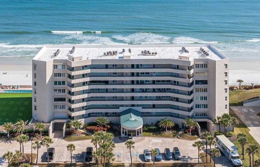 Experience elevated coastal living in this mint-condition, top-floor beachfront condo in the highly sought-after Towers 8 and 9, ideally located in beautiful Ponce Inlet. Perfectly positioned oceanfront, this exceptional 2-bedroom, 2-bath residence offers sweeping views, refreshing sea breezes, and direct access to a private stretch of pristine, no-drive beach — a rare luxury that ensures peace, privacy, and relaxation. Lovingly and meticulously maintained by its owners, the unit is truly move-in ready and reflects pride of ownership throughout. The HVAC system was replaced in 2024, offering energy-efficient comfort year-round. The windows and sliding glass doors have been upgraded to enhance insulation and storm protection, while motorized hurricane shutters add an extra layer of security and convenience at the push of a button. Beautifully updated flooring flows seamlessly throughout the living areas, creating a clean, contemporary aesthetic that perfectly complements the coastal setting. The spacious, well-designed floor plan maximizes both comfort and functionality. The primary suite offers a tranquil retreat with ample space, generous closet storage, and a beautifully maintained en-suite bath. The second bedroom is ideal for guests or a home office, paired with a second full bath that has also been impeccably cared for. An interior laundry room adds everyday convenience — a highly desirable feature that enhances ease of living. Step outside your door and enjoy resort-style amenities reserved exclusively for residents of Towers 8 and 9. Relax beside the sparkling oceanfront pool, unwind in the soothing hot tub, or take advantage of the private beach access just steps away. The community clubhouse provides inviting gathering spaces perfect for entertaining friends and neighbors, along with a well-equipped fitness center to support an active and healthy lifestyle. Additional highlights include a designated parking space and extra storage in the secured parking garage — valuable features that make beachfront living even more practical and convenient. Whether you’re searching for a full-time oceanfront residence, a luxurious seasonal escape, or a smart investment opportunity, this top-floor gem offers the perfect combination of comfort, security, and breathtaking coastal beauty in one of Ponce Inlet’s most desirable beachfront communities.