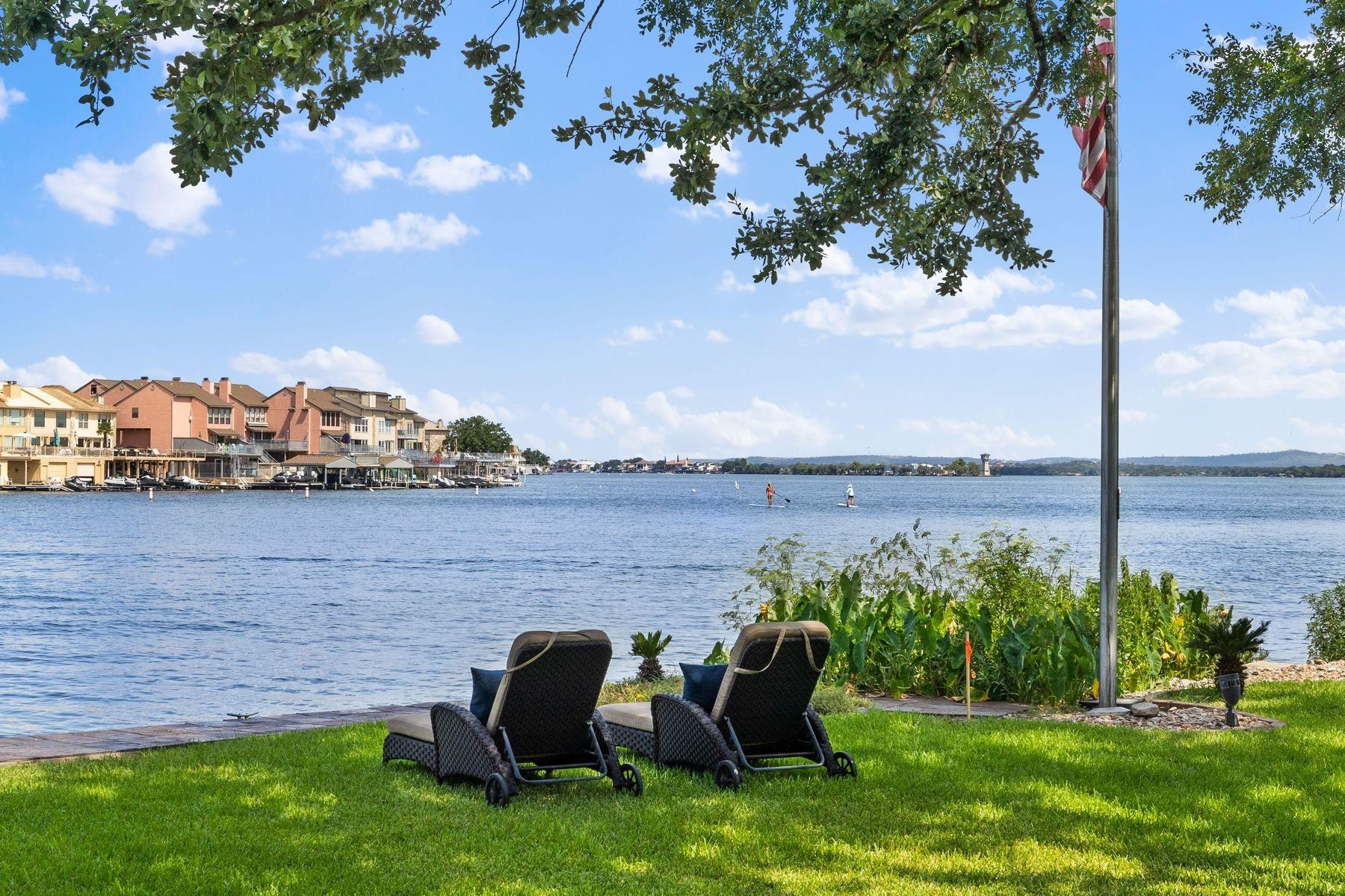 Discover the extraordinary opportunities at 106 Bunny Run on Lake LBJ — a rare gem with 192 feet of spectacular open waterfront consisting of two waterfront lots (0.63 acres total), offering limitless potential to reimagine your dream lake escape. What sets this apart? The flexibility of the additional lot — enjoy it as-is, expand your vision, build a new lake house or two, or sell the lot for added value. Located oh so close to the Horseshoe Bay Resort, you're moments from world-class resort amenities, including golf, dining, the private Jet Center for quick escapes, and endless Lake LBJ adventures: boating, watersports, fishing, paddle boarding, swimming, and pure relaxation. (Membership to The Resort is needed to enjoy the resort amenities)   This thoughtfully designed lake house seamlessly blends casual elegance with breathtaking views, capturing panoramic sights across the water toward Lighthouse Drive in the distance. Step inside to an expansive open-concept living room, formal dining area, gourmet kitchen, wet bar, game room, dedicated office, and workout room with steam shower — all flowing effortlessly to tranquil outdoor spaces. Accommodations include 5 spacious bedrooms and 7 full bathrooms, plus a 2-car garage, Boat House with deck above and 2 jst ski slips — perfect for family gatherings or effortless entertaining. Just 45 minutes northwest of Austin and 90 minutes north of San Antonio in the heart of the beautiful Texas Hill Country.  Come Live Your Best Life on Lake LBJ!