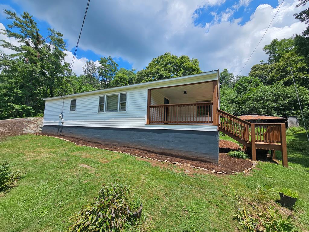 Recently remodeled and clean as a pin, this charming 2-bedroom, 1-bath home offers easy one-level living and plenty of modern updates. Step into a spacious living area featuring a cozy wood stove and luxury vinyl plank flooring. The updated kitchen shines with fresh paint, new countertops, and a convenient bar. The bathroom has been tastefully upgraded with a new vanity and fixtures. Additional features include maintenance-free vinyl siding, a durable metal roof, and a mini-split system for year-round comfort. A covered back porch provides a versatile space that could easily serve as a sunroom. Nestled on a beautiful lot with striking rock outcroppings, this home offers both comfort and character. Located just minutes from the town of Independence, the New River, and Grayson Highlands State Park, it's an ideal spot for nature lovers or those seeking a peaceful retreat.