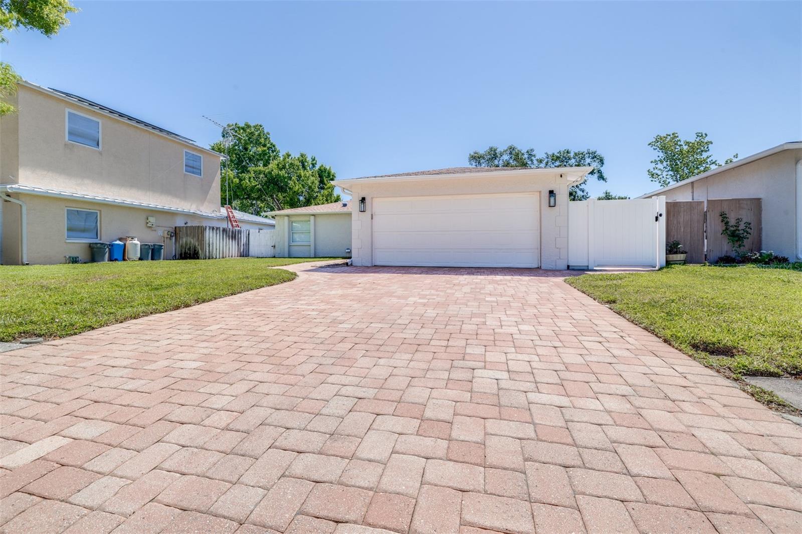 Welcome to 11147 Longhill Dr in Pinellas Park. This well maintained 3 bedroom 2 bath home offers the kind of comfortable Florida living that is hard to find at this price point. The open floor plan feels bright and spacious with newer tile flooring throughout, making the space easy to maintain and move in ready. The kitchen features newer stainless steel appliances and flows naturally into the main living area. A 2 car garage and a beautifully pavered driveway give this home standout curb appeal from the moment you pull up, complemented by a neatly kept lawn and mature landscaping. Out back you will find a fully fenced yard with banana trees, avocado trees, papaya and other tropical plantings that give this outdoor space a true Florida feel. Whether you are entertaining or just unwinding, the backyard has a charm you do not find every day. The roof was replaced in 2020, giving the next owner confidence and value from day one. Pinellas Park is centrally located with easy access to the beaches, downtown St. Pete and Tampa, making this a smart buy for anyone looking to plant roots in Pinellas County.