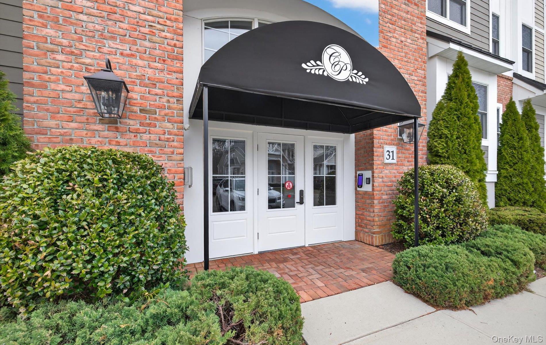 Discover refined, one-level living in this very sought-after Barclay model, a corner end unit in the prestigious gated community of Country Pointe, Plainview. This sun-drenched 2-bedroom, 2-bath residence offers an open floor plan filled with natural light, neutral decor, hardwood floors, custom electric blinds and soaring ceilings throughout. The chef’s kitchen is thoughtfully designed with gas cooking, stainless steel appliances, quartz countertops and a center island—perfect for both everyday living and entertaining. The lavish primary suite is a true retreat, featuring two walk-in closets and a spacious spa-like private bathroom. A generous second ensuite bedroom serves perfectly as a guest room or home office. Enjoy seamless indoor-outdoor living with access to a maintenance-free private terrace, ideal for morning coffee or evening relaxation. Additional highlights include reserved lower-level indoor parking, private storage, easy elevator access and ample guest parking. Country Pointe delivers a resort-style lifestyle with 24/7 gated, manned security, concierge services, EV charging stations, and a full-time Director of Events. Amenities include a magnificent clubhouse with ballroom, theatre, library, dining areas, fitness center, exercise classes, two heated pools with poolside bar, tennis, pickleball, bocce courts, card and game rooms, sports and social bar and meticulously landscaped grounds. Minutes to world-class golf, Country Pointe Shops, dining, entertainment and transportation. This is more than a home—it’s luxury, convenience and lifestyle at its finest.