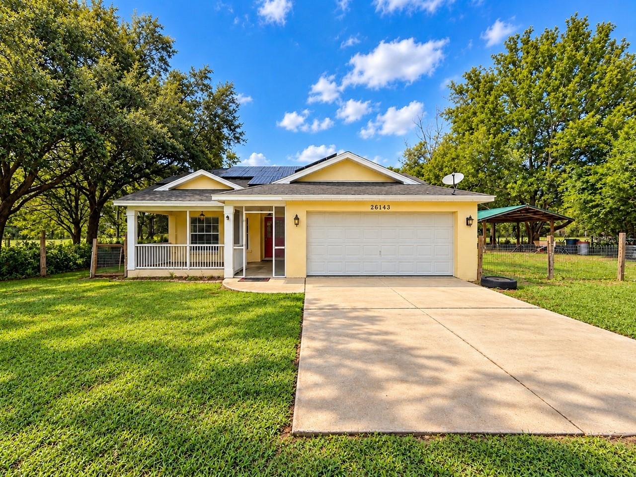 Welcome to 26143 Lambeth Road in Brooksville! Situated on approximately 2 acres, this 3-bedroom, 2-bath pool home with a 2-car garage offers plenty of space, privacy, and versatility. Set back from the main road, the property features an expansive yard, screen-enclosed swimming pool, large covered patio, and plenty of room to enjoy the outdoors.Inside, you’ll find a bright, open layout with vaulted ceilings, updated flooring, spacious living areas, and a kitchen with breakfast bar and stainless-steel refrigerator. The home has been recently updated, offering a clean, move-in-ready feel.Outside, you’ll find an additional covered structure ideal for parking, equipment, recreational vehicles, storage, or other uses, along with a chicken coop and plenty of open space for gardening, animals, toys, and more. The home also features a modern Enphase solar system with IQ microinverter technology and integrated monitoring, which will be completely paid off by the seller at closing.Enjoy the privacy of acreage with the convenience of a pool home and numerous recent improvements—and a few more upgrades are still to come!