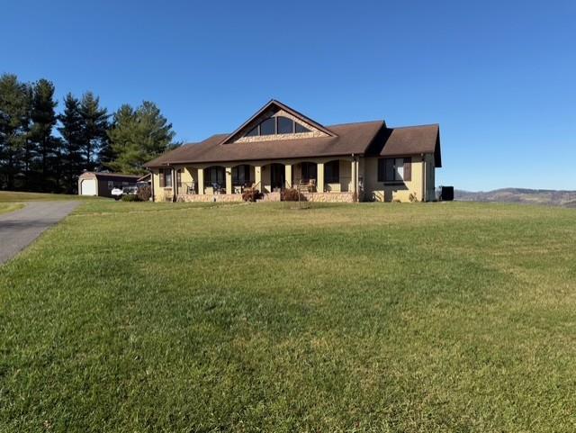 Back on the market no fault of the home.Total brick home sitting on 4.29 acres of beautiful land with a stunning mountain view and privacy.   This home features over 4100 sq. ft on one level with both a formal living and dining area, a sunken den with fireplace and large windows that focus on framing the outdoor mountain view.  An Updated kitchen with granite counter tops, double ovens, island and breakfast area.  A primary bedroom suite for the owner with setting area, an oversized closet, large bath with jet tub, walk in shower, off of the den area.  The second suite offers new hardwood flooring and an updated bath.  Two additional bedrooms, one additional full and 1/2 bath on this level.  An oversized laundry area with pantry and a home office complete the main level.   An 800 + sq ft basement with a third fireplace for additional living space, plus a one bedroom apartment at the rear of the detached garage for the extended family or guest!  Private outdoor entertaining on the rear patio  ( 280 Sq Ft) plus a covered front porch for summertime porch sitting are additional pluses to this beautifully maintained and well loved home  that is awaiting a new owner.  Regardless If you're looking for a nice place to retire or your family needs additional space, call to see this home today.