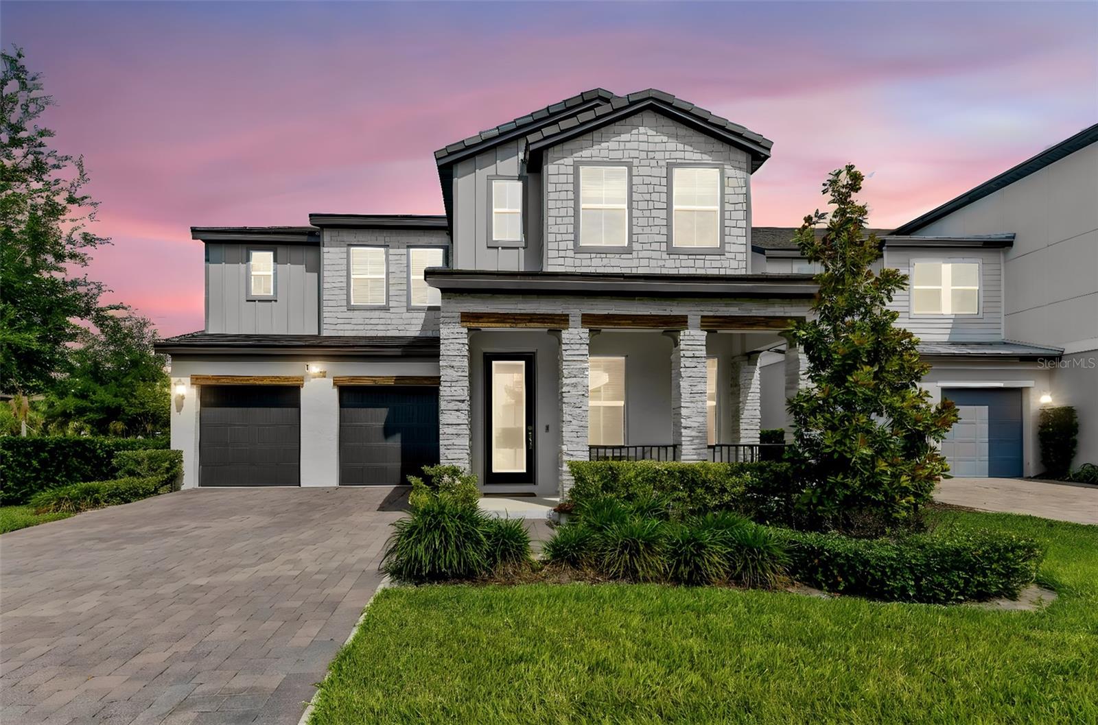 Welcome to luxury living in the highly sought-after gated community of Sand Lake Sound in the heart of Dr. Phillips. Built in 2022 by Meritage Homes, this extensively upgraded Hayden model offers 4,015 square feet of thoughtfully designed living space with 5 bedrooms, 4.5 bathrooms, a private office, spacious loft, resort-style outdoor living & more than $300,000 in premium upgrades. Situated on a beautifully landscaped homesite, this modern residence showcases exceptional curb appeal with massively upgraded internal & exterior finishes, a paved driveway, covered front porch & elegant architectural details throughout. Inside, the home features an open-concept floorplan, luxury vinyl plank flooring throughout the main living areas & bedrooms, modern 5.25-inch baseboards, upgraded 8-foot interior doors, a dramatic custom staircase with silver aluminum railings, stainless steel cables & oak treads stained in midnight finish. The gourmet chef’s kitchen serves as the centerpiece of the home & was extensively upgraded to include premium KitchenAid stainless steel appliances, a 36-inch 5-element cooktop, built-in convection oven & microwave combo, modern hood, LG InstaView French Door Fridge, stacked 42-inch cabinetry, designer hardware, a large walk-in pantry & an oversized quartz waterfall island. The first floor also includes a private office, guest suite with full bath, powder room &spacious casual dining area overlooking the outdoor entertainment space. The open dining & living room areas provide the perfect space for entertaining & everyday luxury living. Upstairs, the expansive primary retreat offers a luxurious sitting room with direct balcony access, tray ceilings, an en-suite spa-inspired bathroom with dual vanities & quartz countertops, a frameless glass shower enclosure, designer tile finishes, & an oversized walk-in closet. The upstairs loft provides flexible living space ideal for a media room, game room, or secondary family area. All additional bedrooms feature walk-in closets, upgraded bathrooms with quartz countertops, designer tile packages, frameless shower enclosures & modern fixtures. The outdoor living experience rivals a private resort. The backyard features a covered lanai, oversized screened enclosure, custom saltwater pool & spa with glass tile finishes, bubblers, water descents, auto-fill/auto-drain system, spa blower & a Jandy heat/chill system. Enjoy views of Orlando Eye & a splash pad from the balcony & backyard entertainment area. This residence is a perfect living option for work or entertainment as it features wired data cables throughout the entire home, so it is ideal for a home office, AprilAire HVAC system for a healthy air living, electric vehicle charging in garage, whole-house surge protection, Ring security system, 3-stage osmosis water filter, whole-house faux wood blinds, custom window treatments, garage epoxy flooring, summer kitchen rough-in & water softener. Sand Lake Sound residents enjoy resort-style amenities including a community pool, splash pad, playground, dog park, clubhouse, sidewalks, kayak launch & private dock access to Big Sand Lake.Located just minutes from Orlando’s famous Restaurant Row, Whole Foods, Trader Joe’s, Universal Studios, Disney attractions, International Drive & major highways, this home offers the perfect combination of luxury & modern Florida living. This exceptional upgraded residence is a rare opportunity to own one of the finest homes in Sand Lake Sound